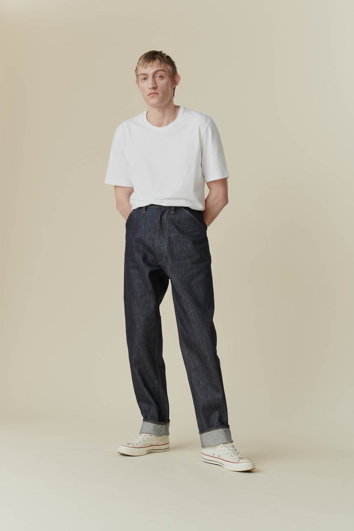 Full body front shot of male in chore jean indigo