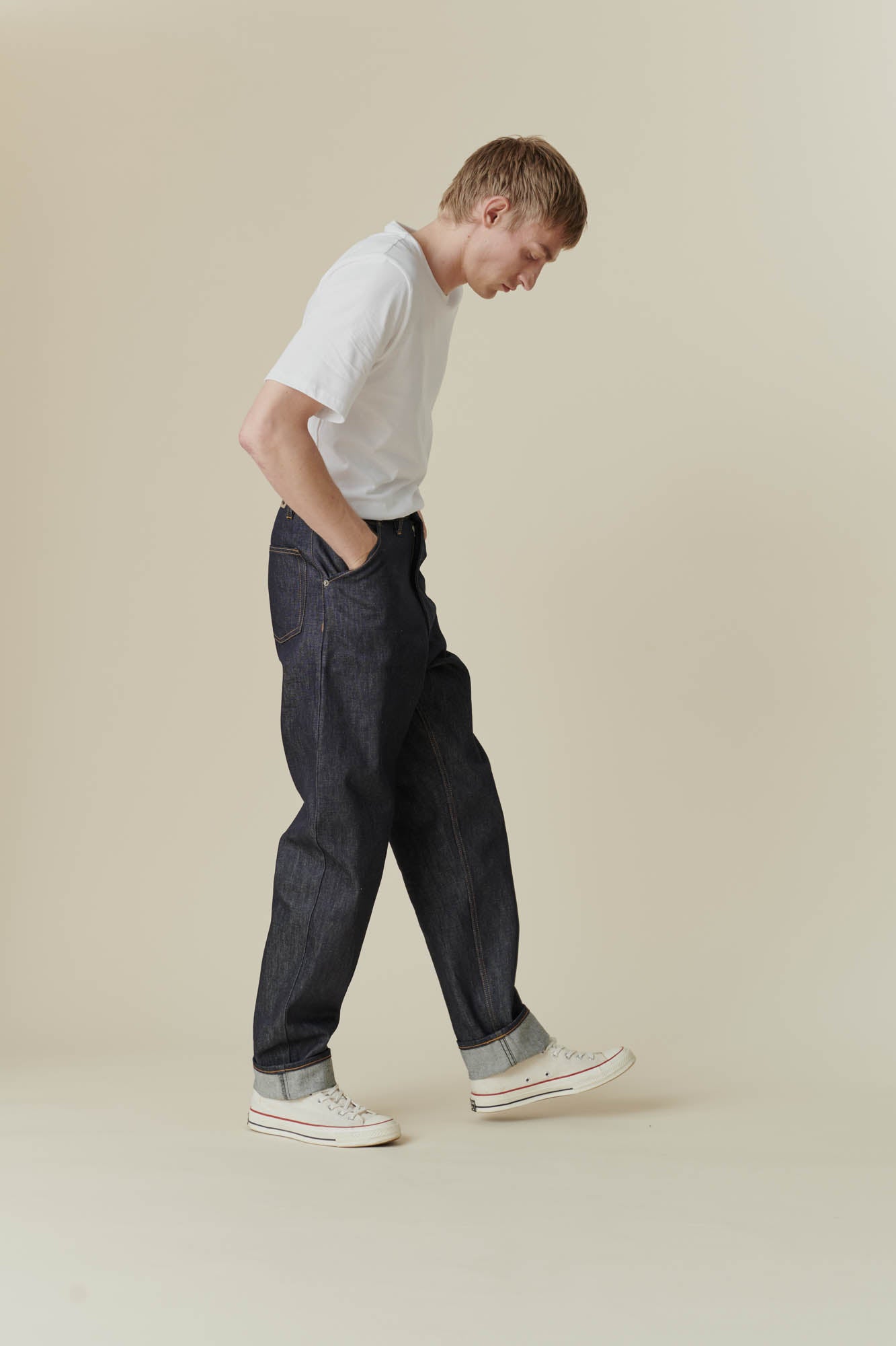 Full body front shot of male in chore jean indigo