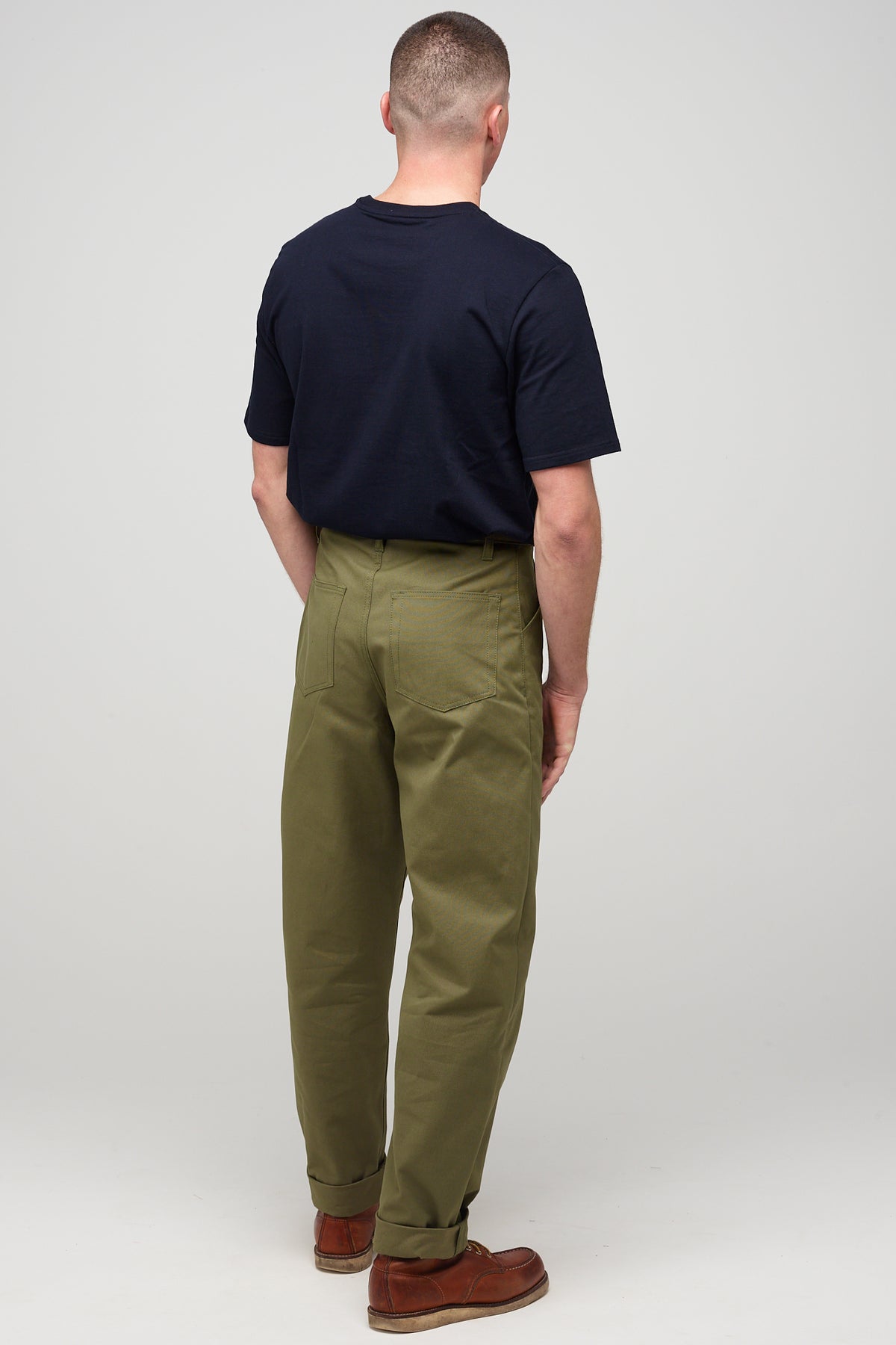 
            Brunette, white male wearing chore trousers in olive