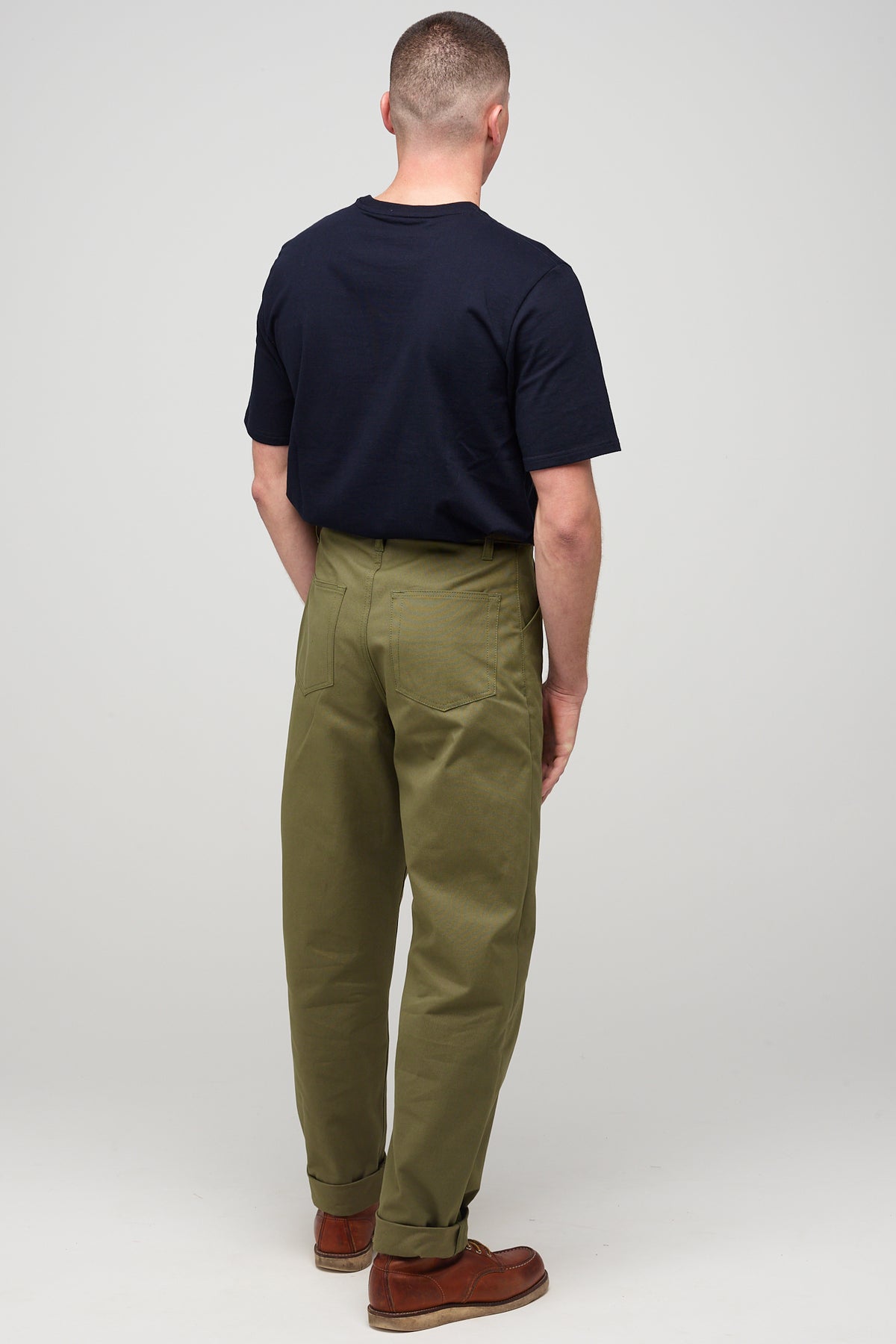 Brunette, white male wearing chore trousers in olive