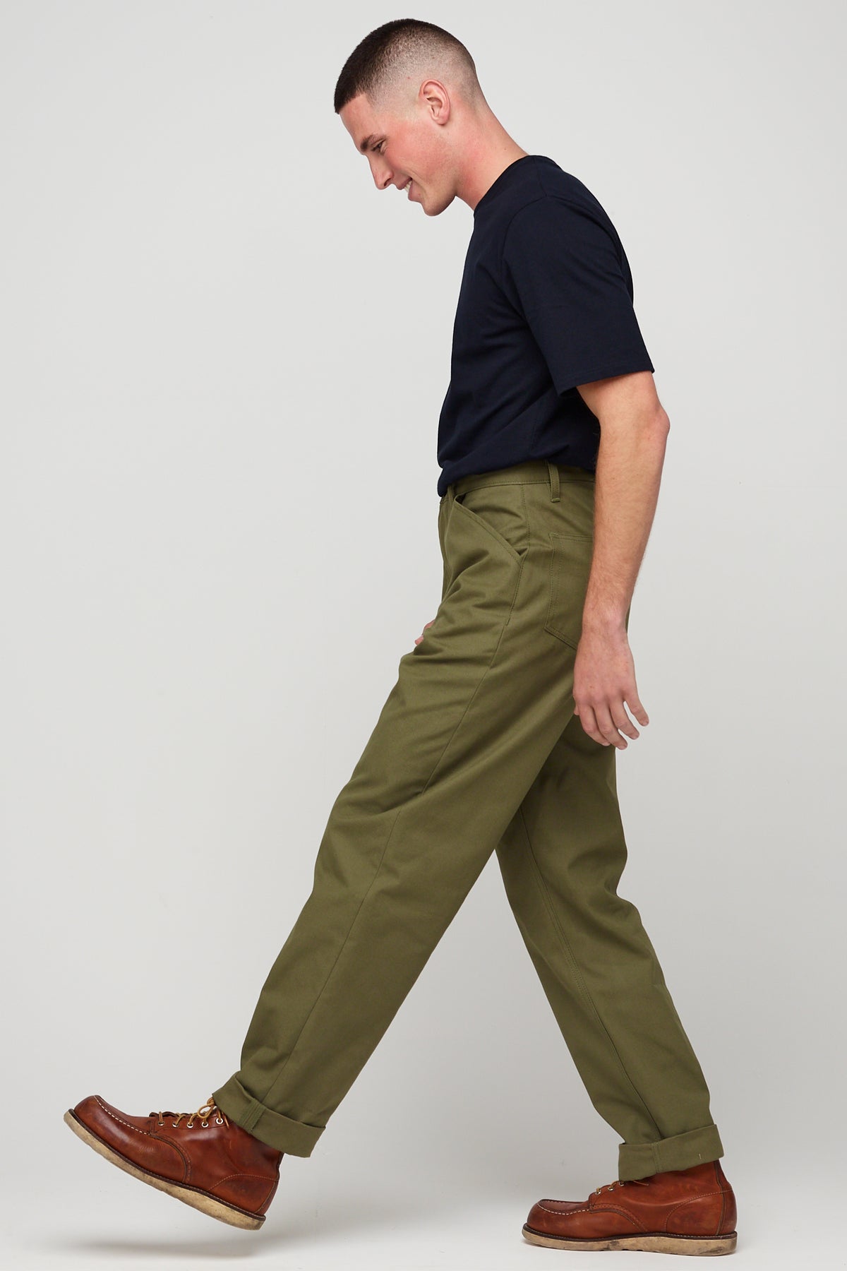 Brunette, white male wearing chore trousers in olive