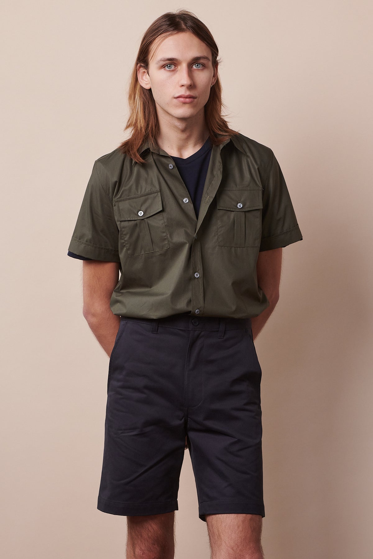 Male wearing classic short in dark navy paired with tom military shirt in olive