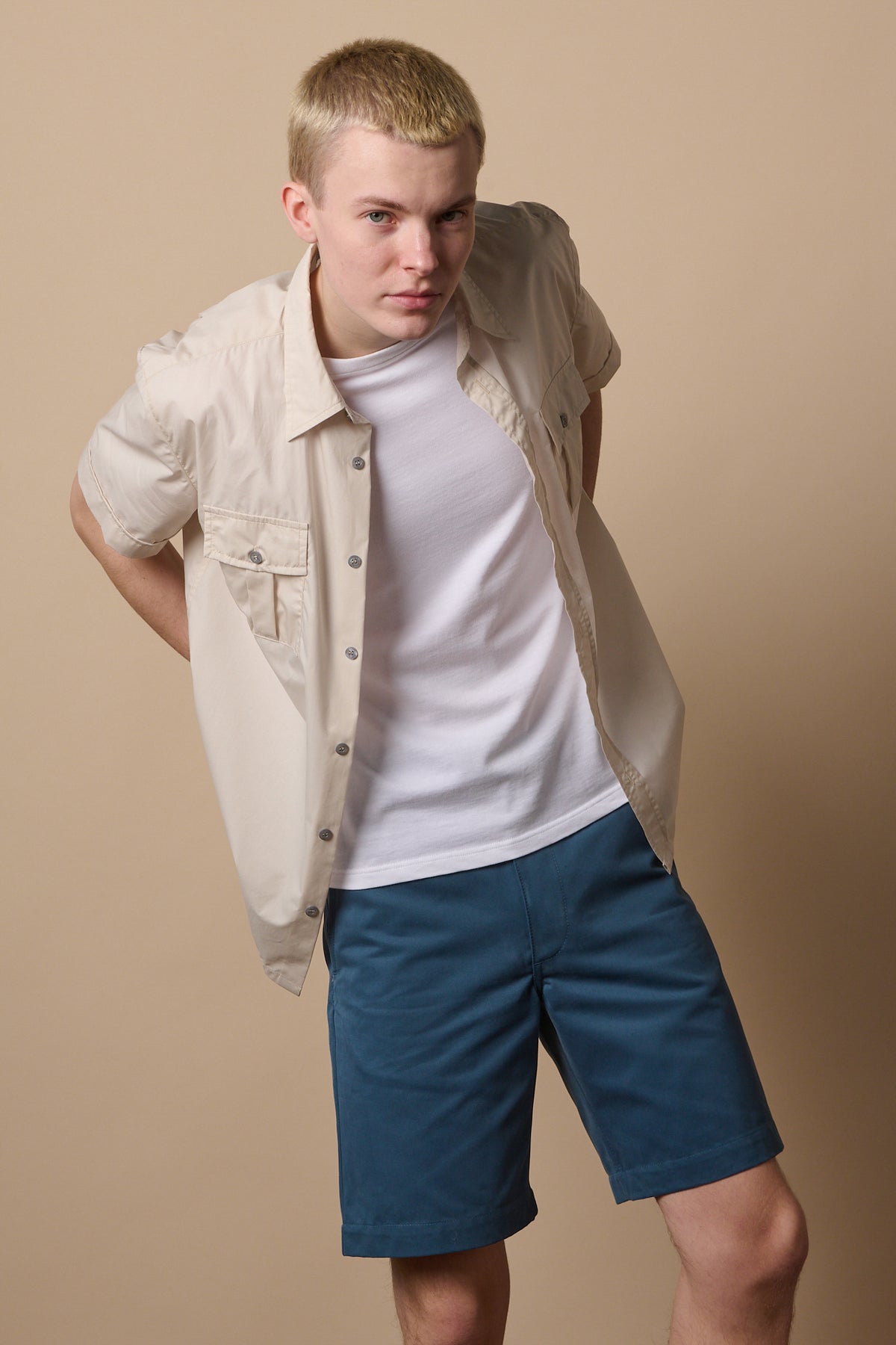 Blonde male wearing classic shorts in RAF blue