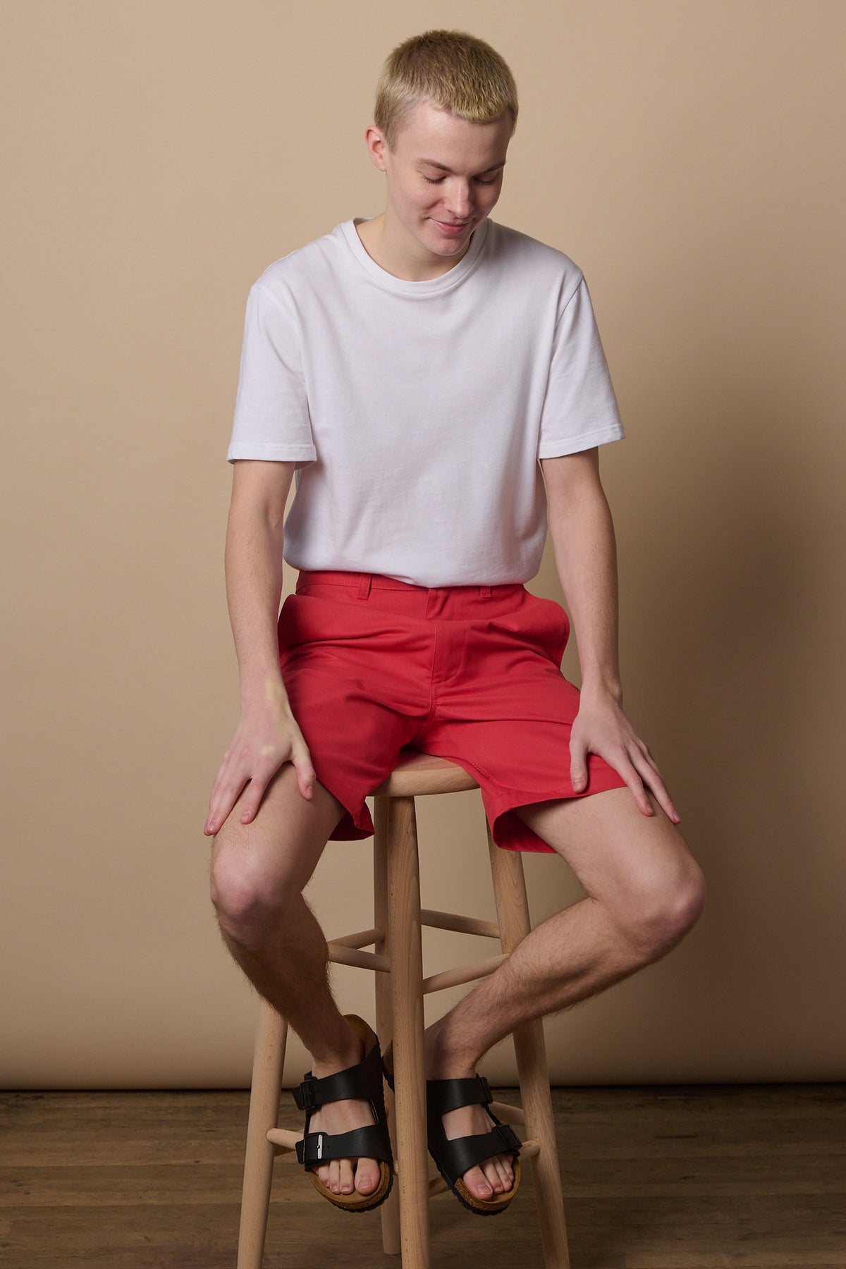 
            Full body image of white male wearing classic shorts in salmon blue paired with short sleeve white t shirt