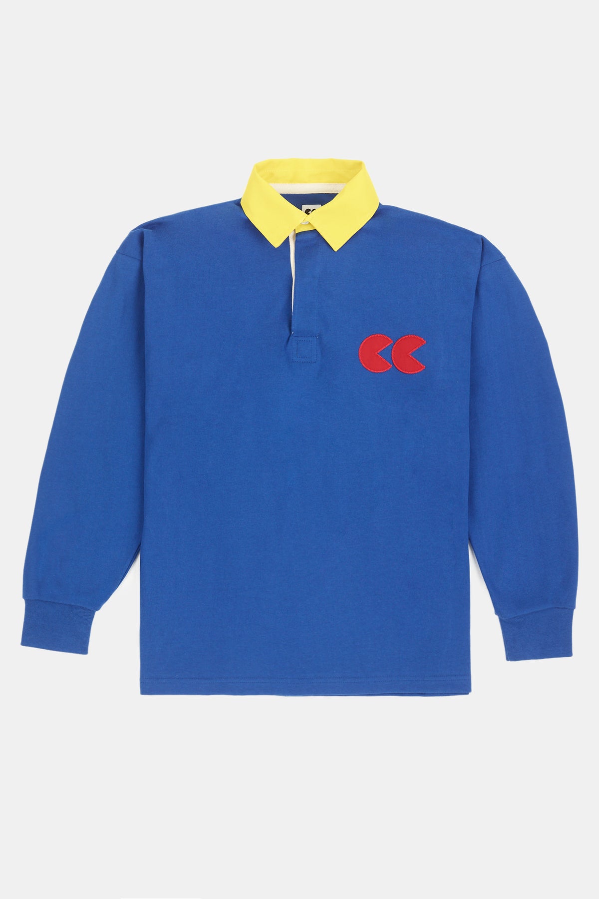 Flatlay of contrast collar rugby shirt in blue with yellow contrast collar and red CC logo applique on the chest