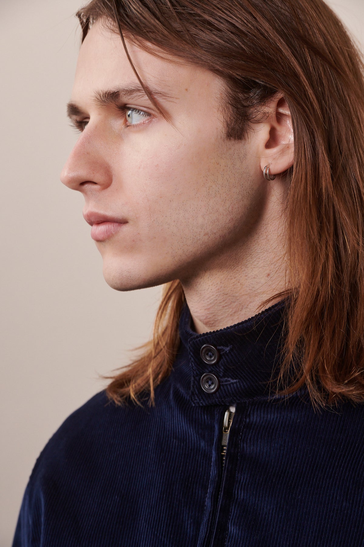 
            Portrait image of male showing close up of collar of the corduroy Harrington in navy 