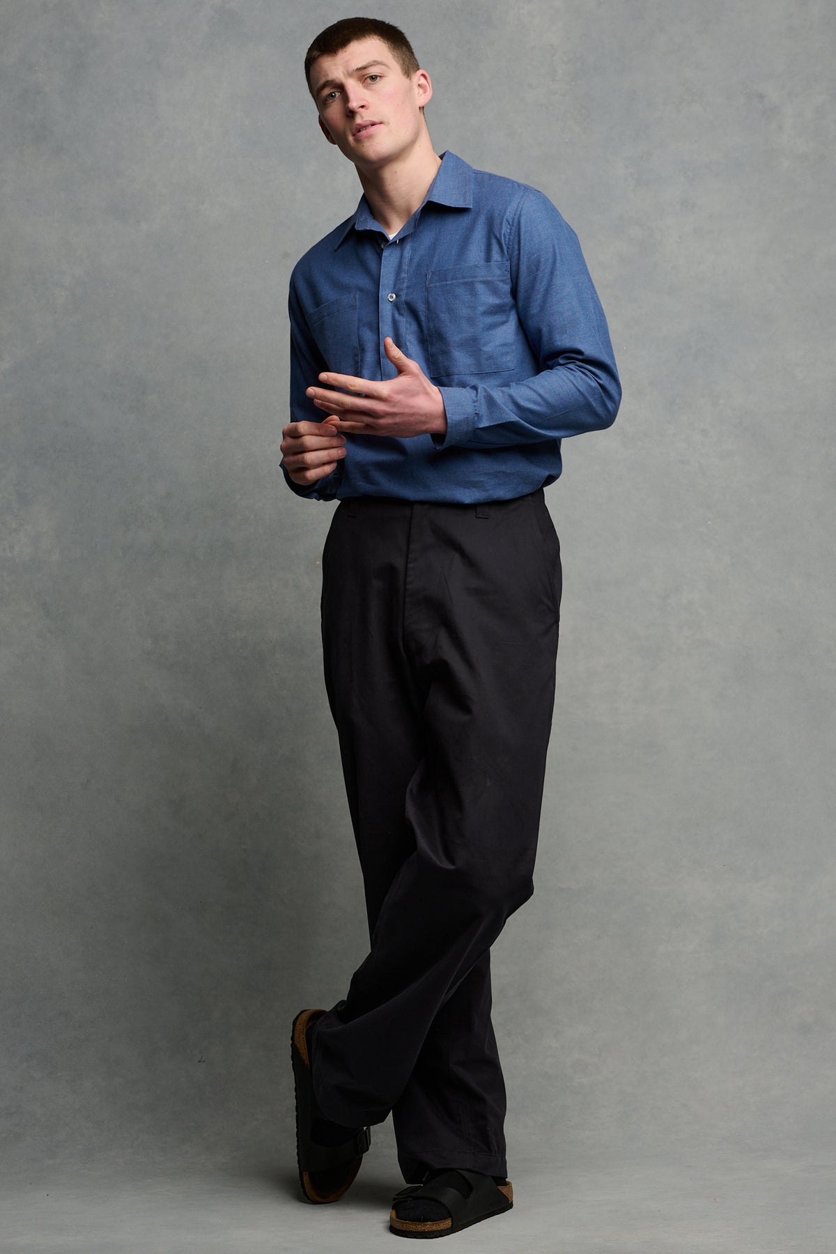 
            Full body image of brunet male wearing navy field trousers paired with Oli half placket lightweight shirt in RAF blue tucked into trousers
