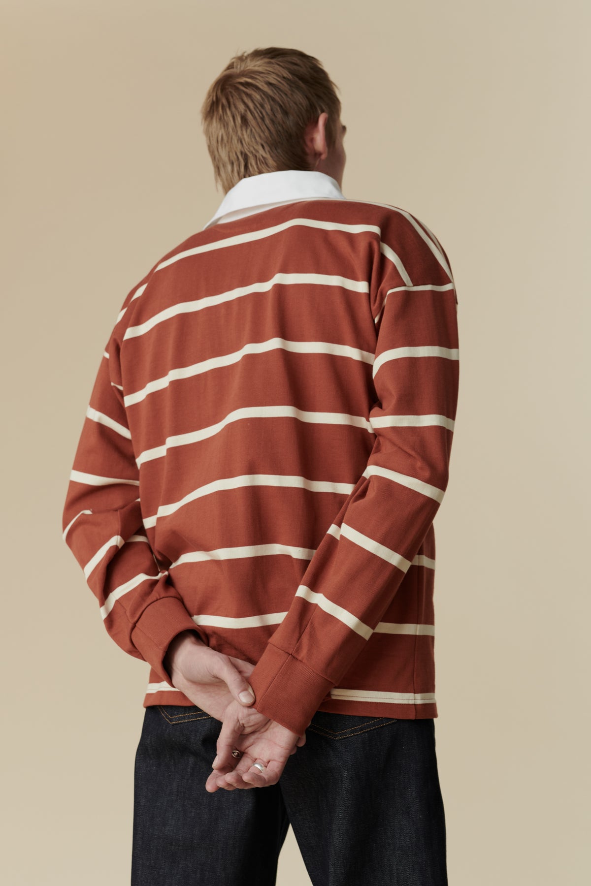 image from behind of male wearing rugby shirt in cinnamon and ecru