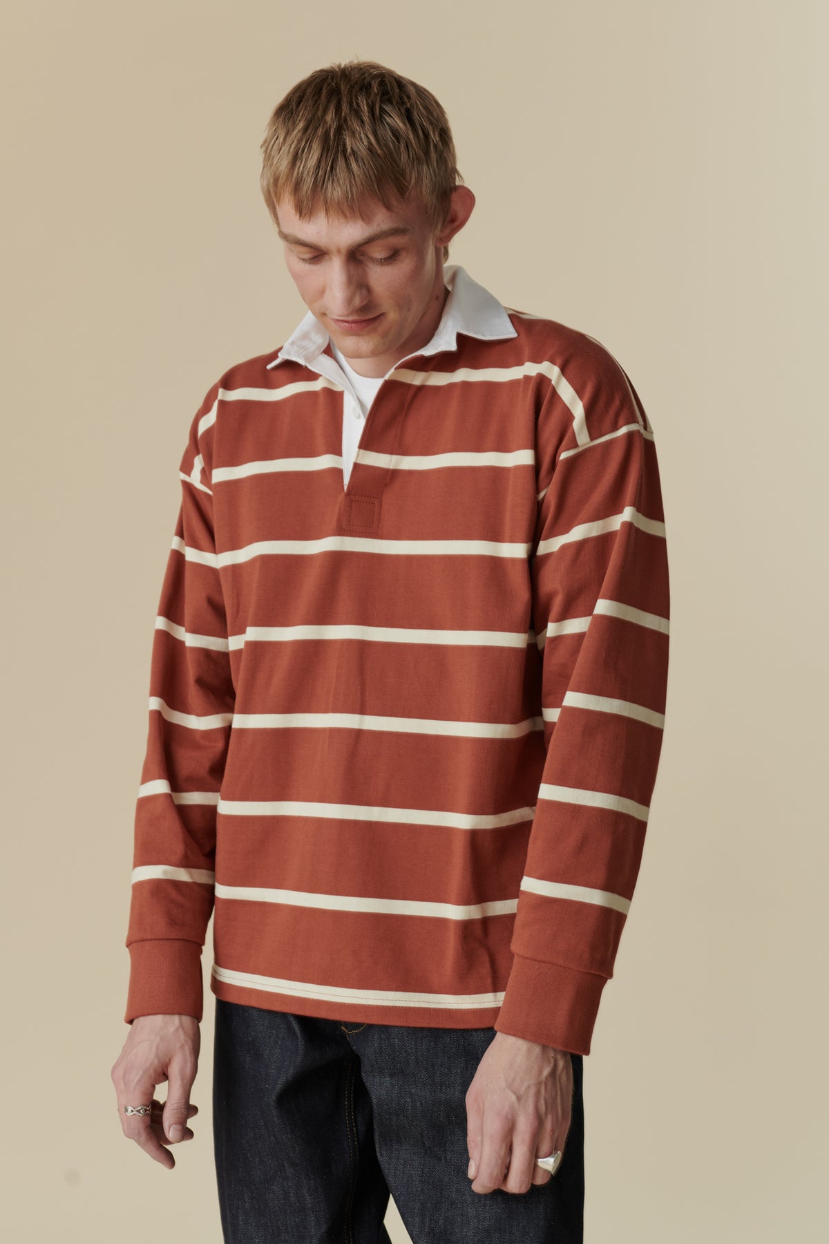 Male wearing rugby shirt in cinnamon and ecru