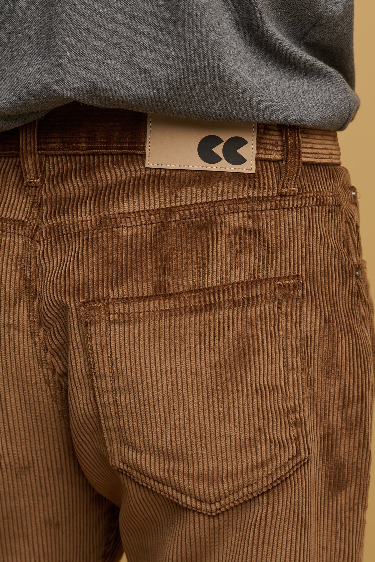 
            Close up of the two back pockets, with belt loop and CC logo patch on waistband