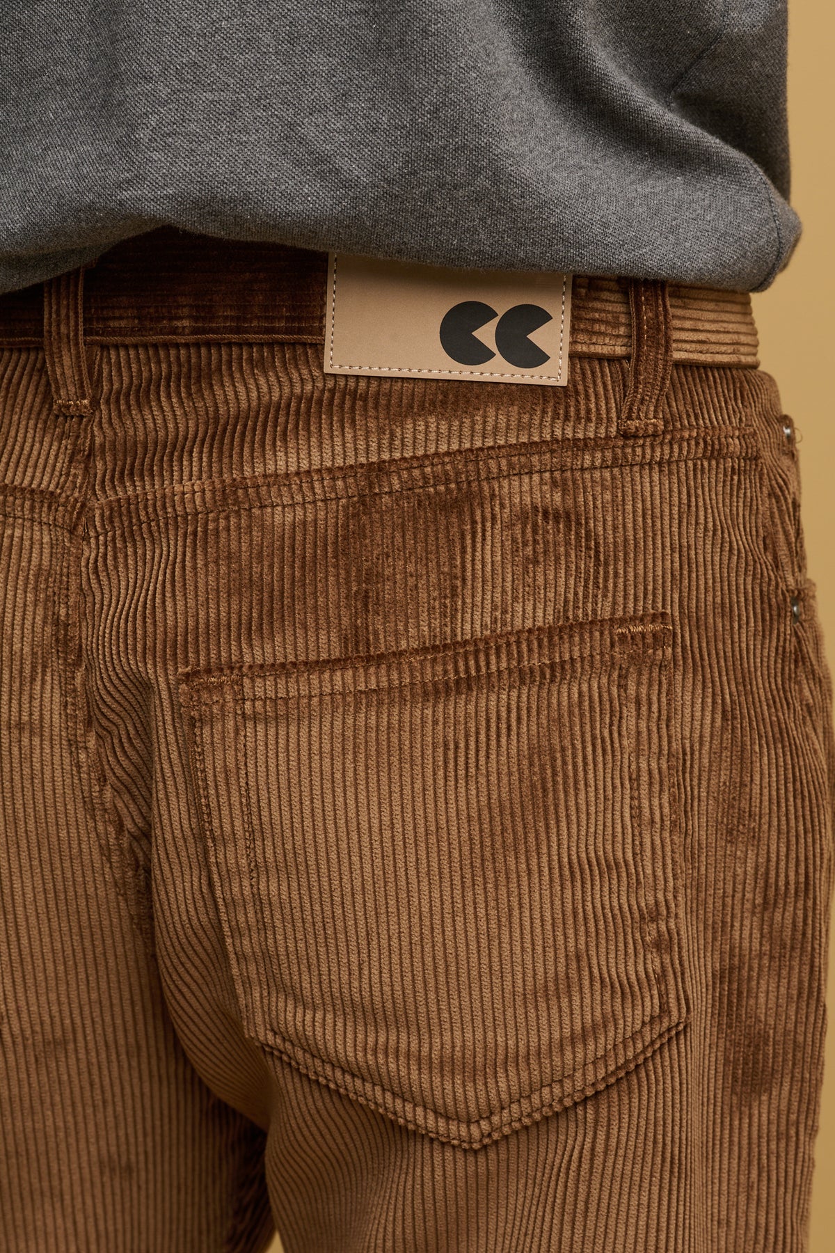 Close up of the two back pockets, with belt loop and CC logo patch on waistband
