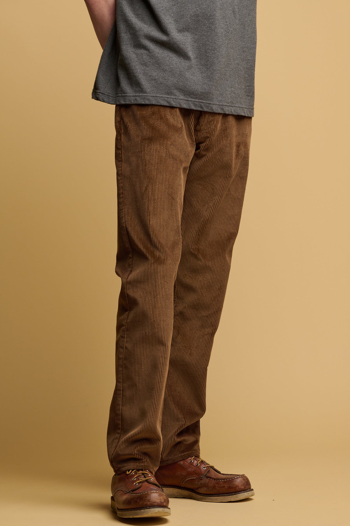 The front of male waist down wearing cord trousers in tan
