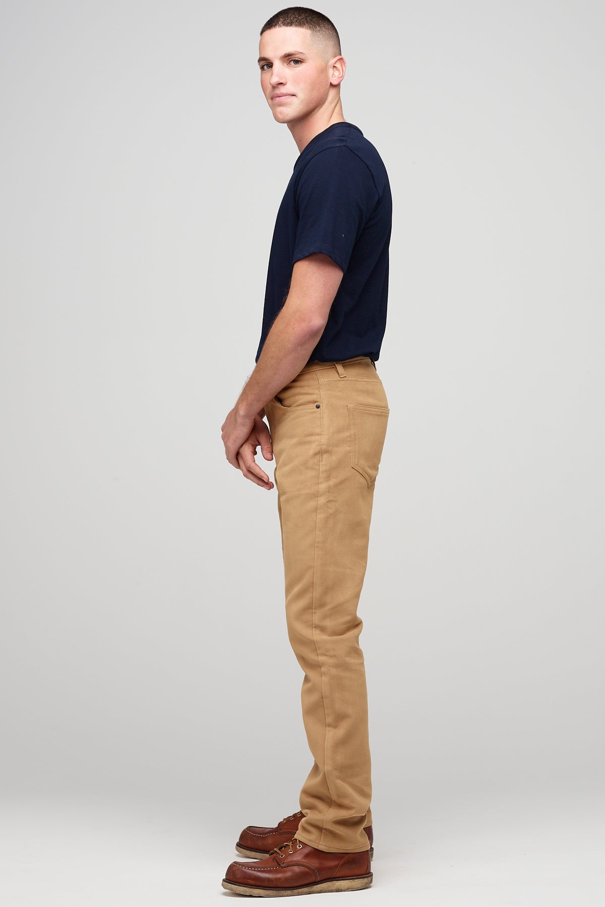 
            Male brunette wearing five pocket moleskin jeans in camel styled with black t-shirt