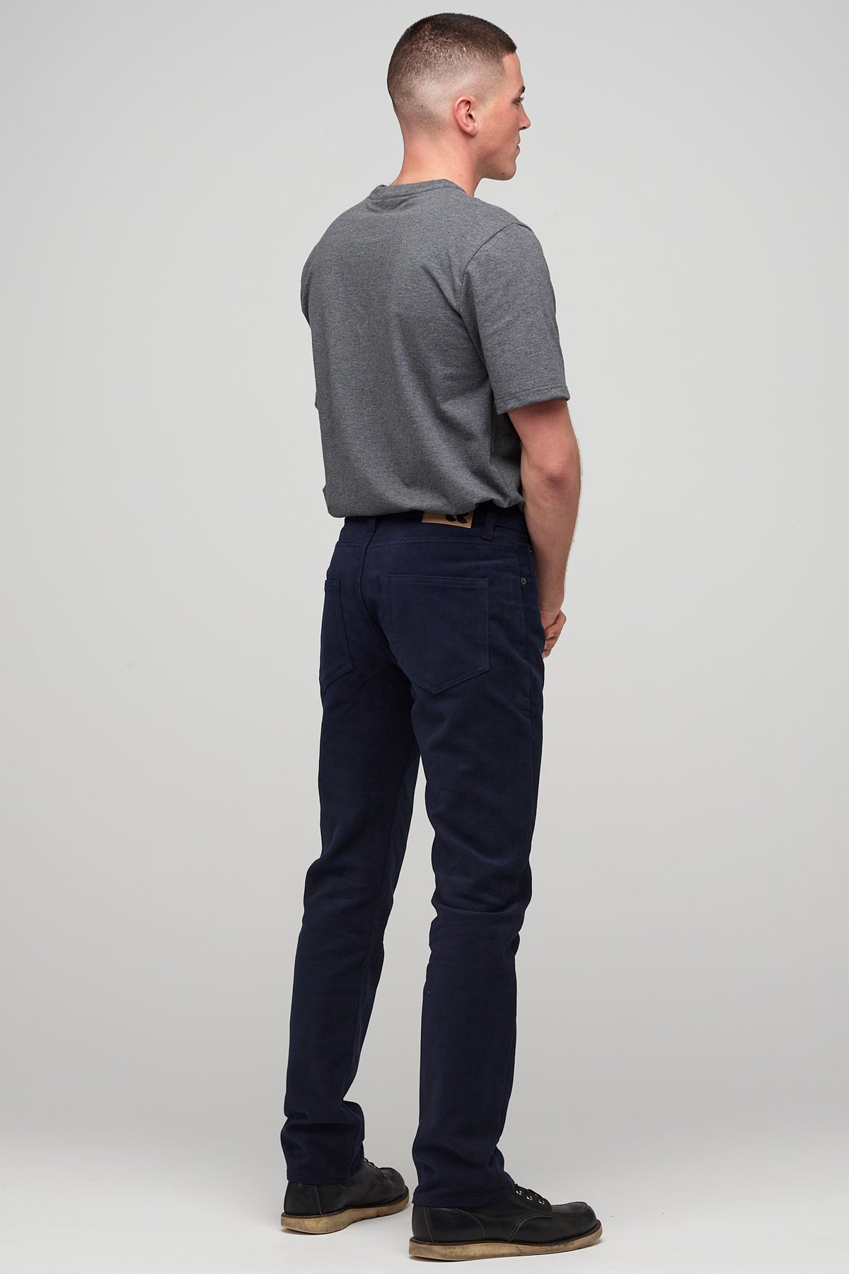 Brunette male in navy Five Pocket Moleskin Jean styled with charcoal short sleeve t-shirt