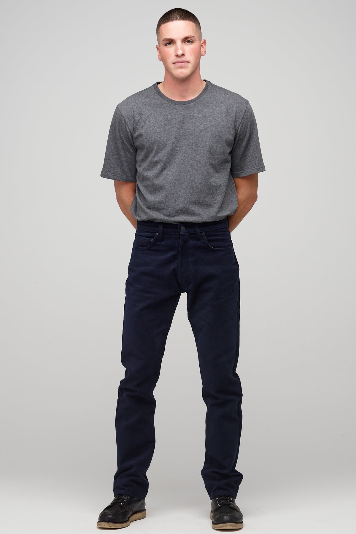 Brunette male in navy Five Pocket Moleskin Jean styled with charcoal short sleeve t-shirt