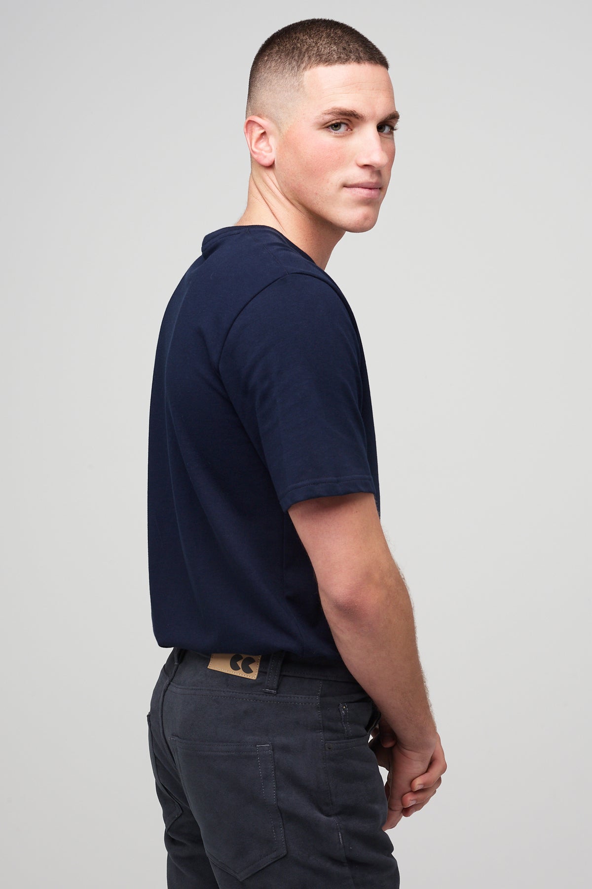 Brunette white male wearing navy Five Pocket Moleskin Jeans styled with navy short sleeve t-shirt and black shoes
