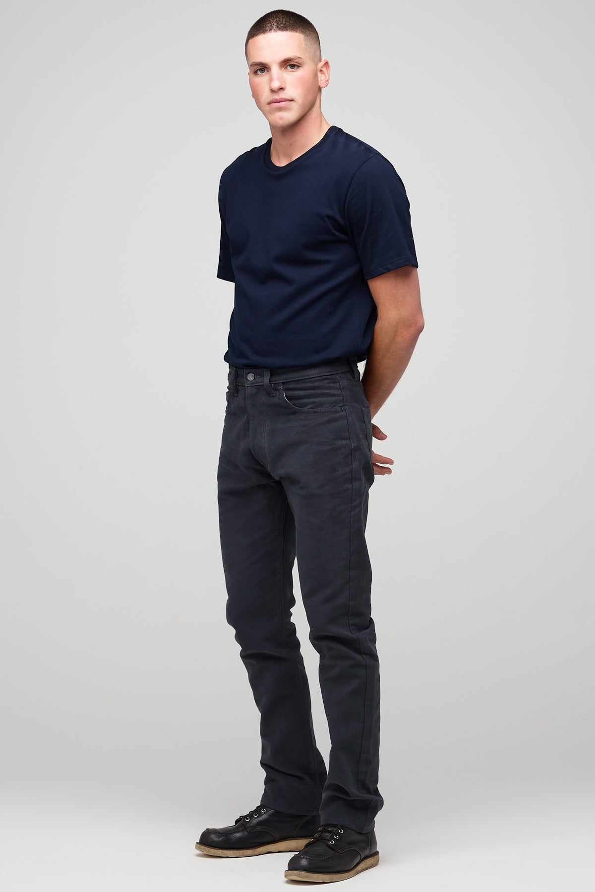 Brunette white male wearing navy Five Pocket Moleskin Jeans styled with navy short sleeve t-shirt and black shoes