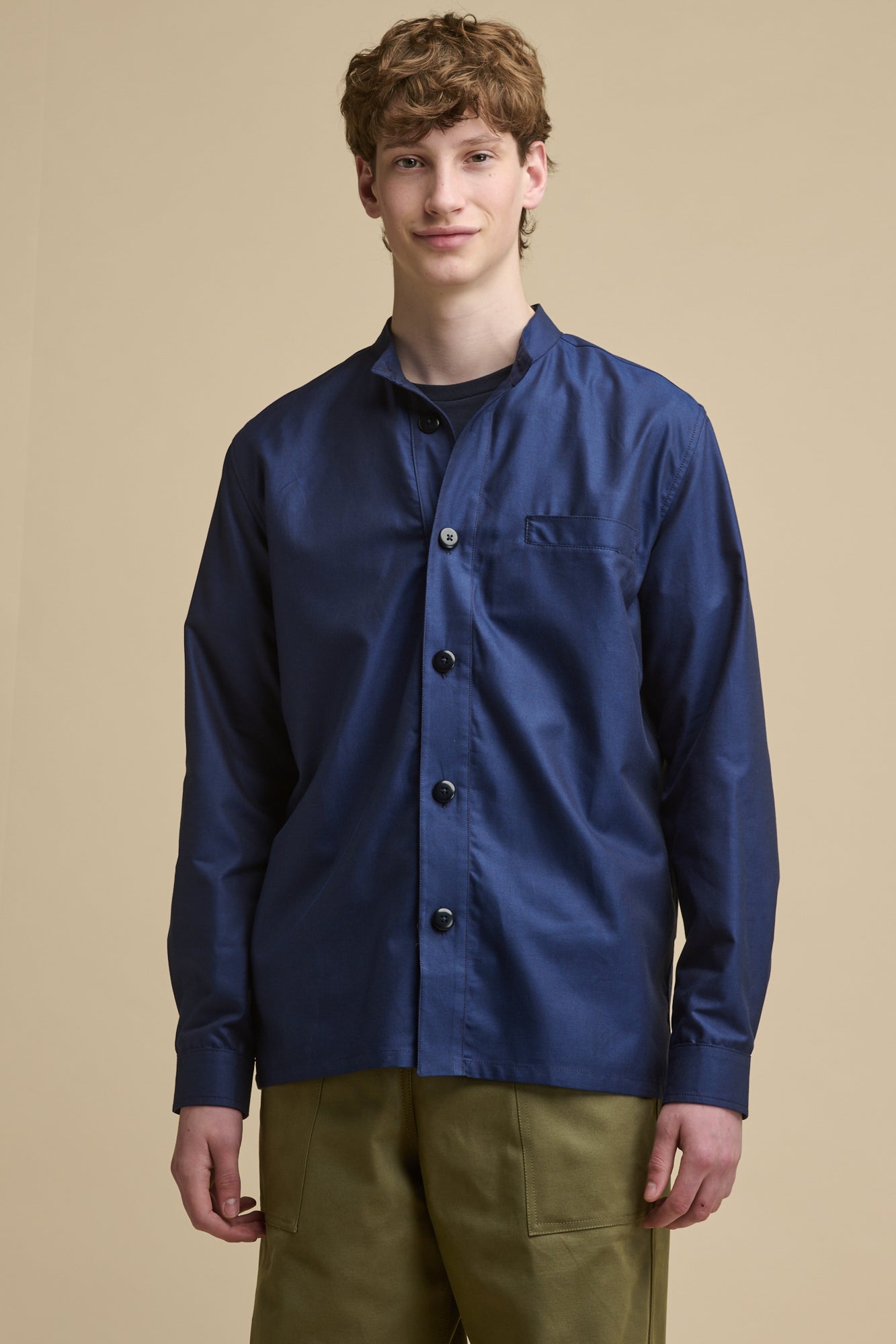 Smiley male wearing George Lightweight Collarless Overshirt in navy with top two buttons undone with navy t shirt underneath