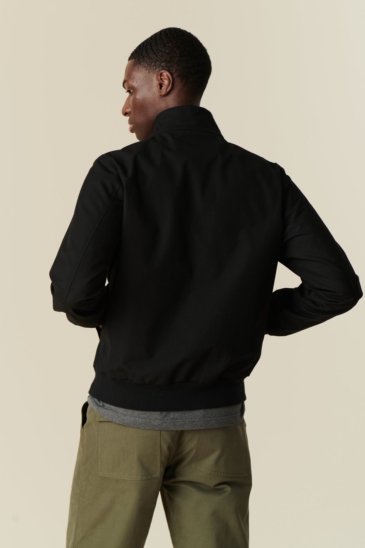 ack of male wearing black Harrington jacket