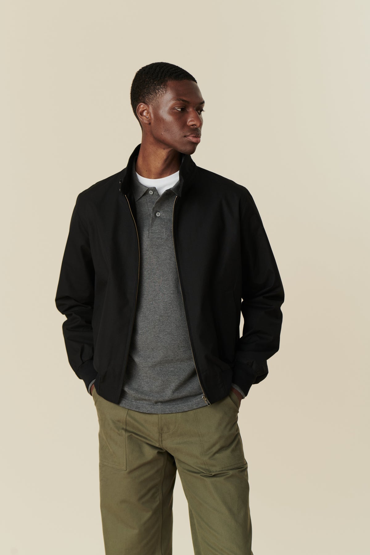 Front of male wearing black Harrington jacket