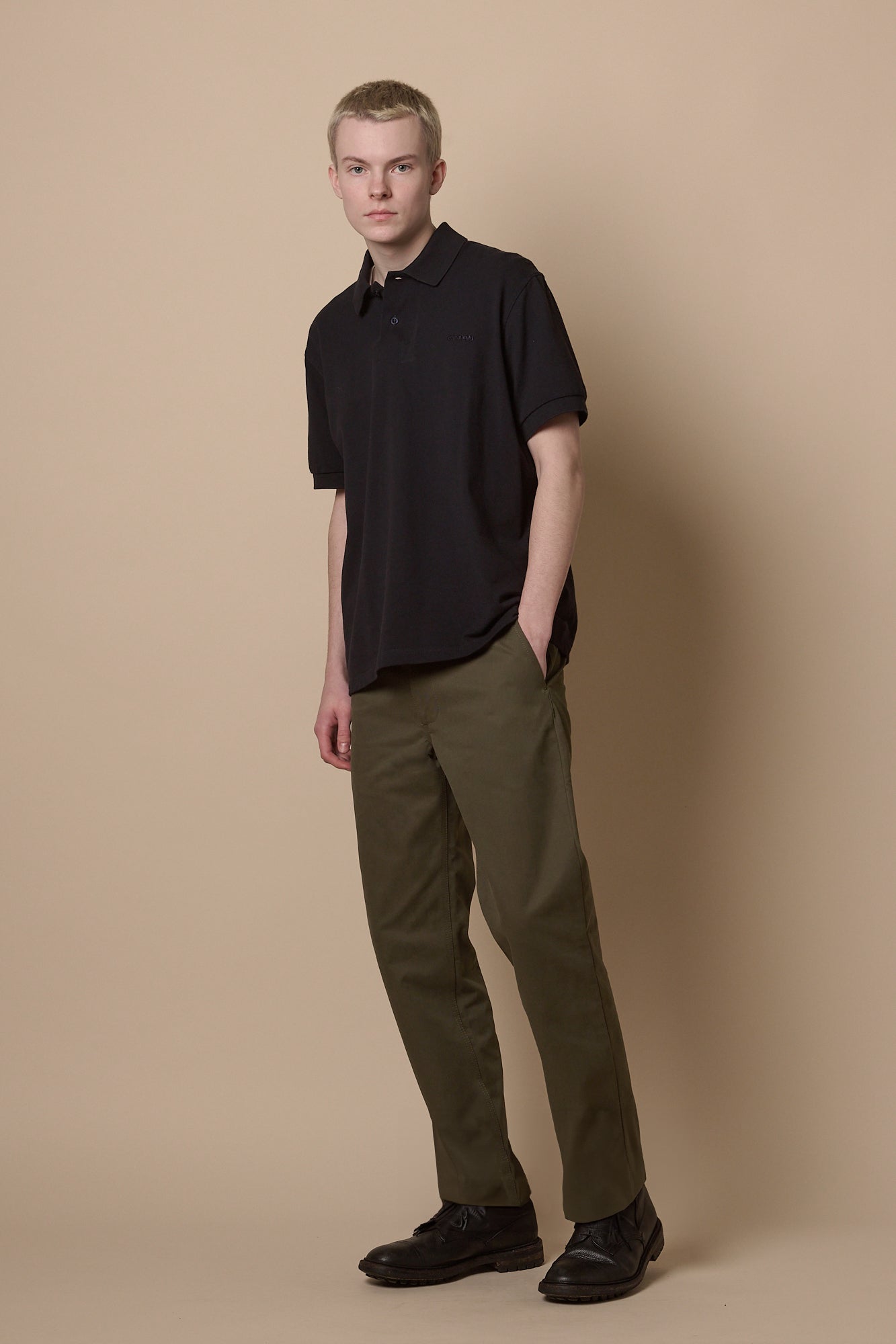Full body image of male wearing heavyweight slim chino in olive paired with short sleeve polo shirt