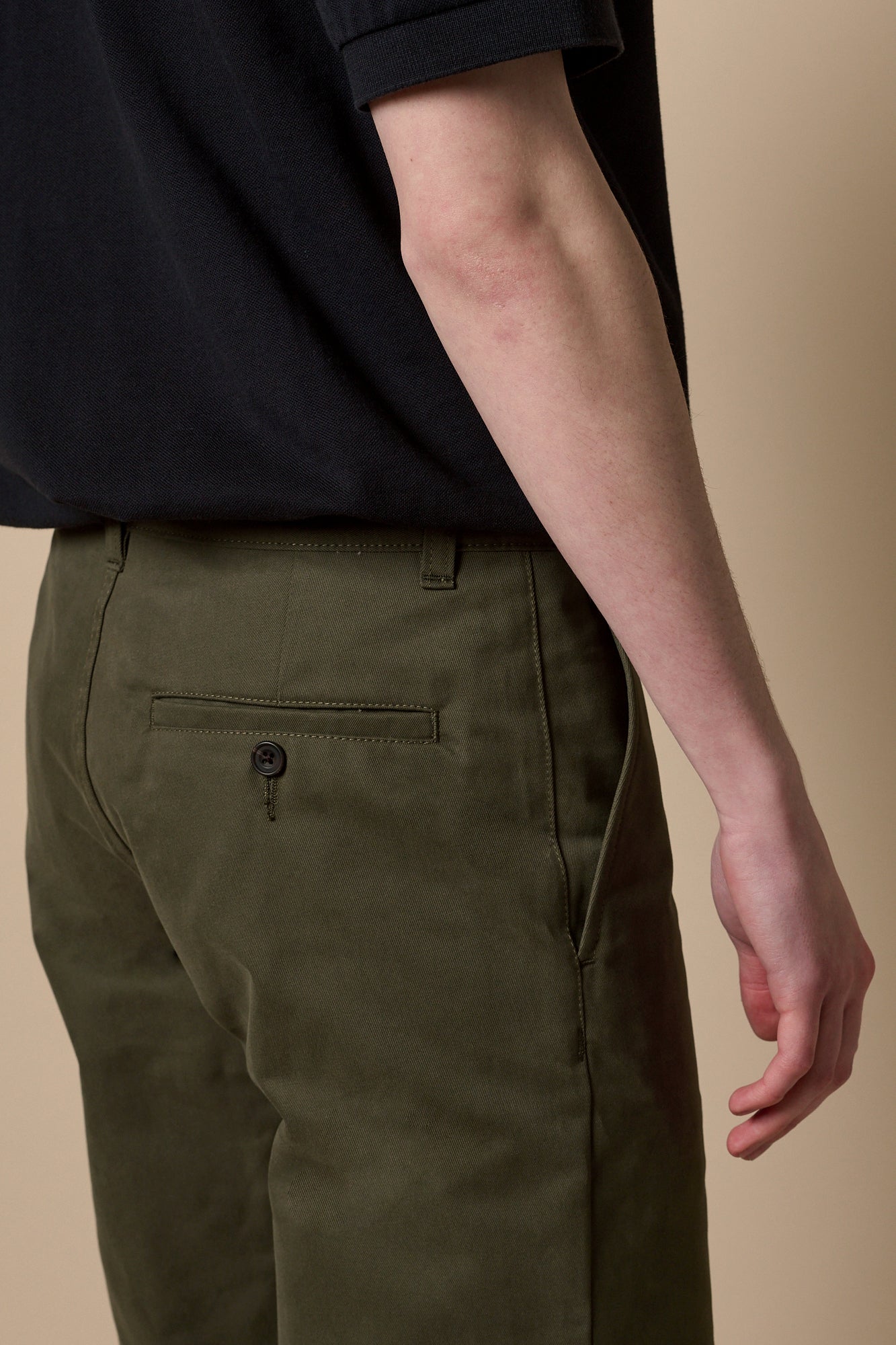 Full body image of male wearing heavyweight slim chino in olive paired with short sleeve polo shirt