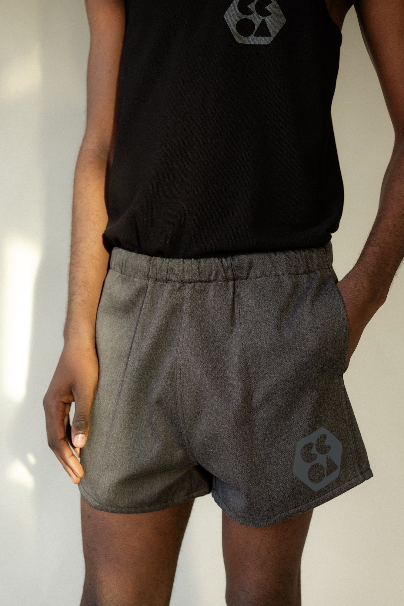 https://communityclothing.co.uk/cdn/shop/files/Male_Heavyweight-Sport-Short-Plastic-Free_Charcoal-Marl_Knee-To-Chest-Front_2048x.jpg?v=1705136677