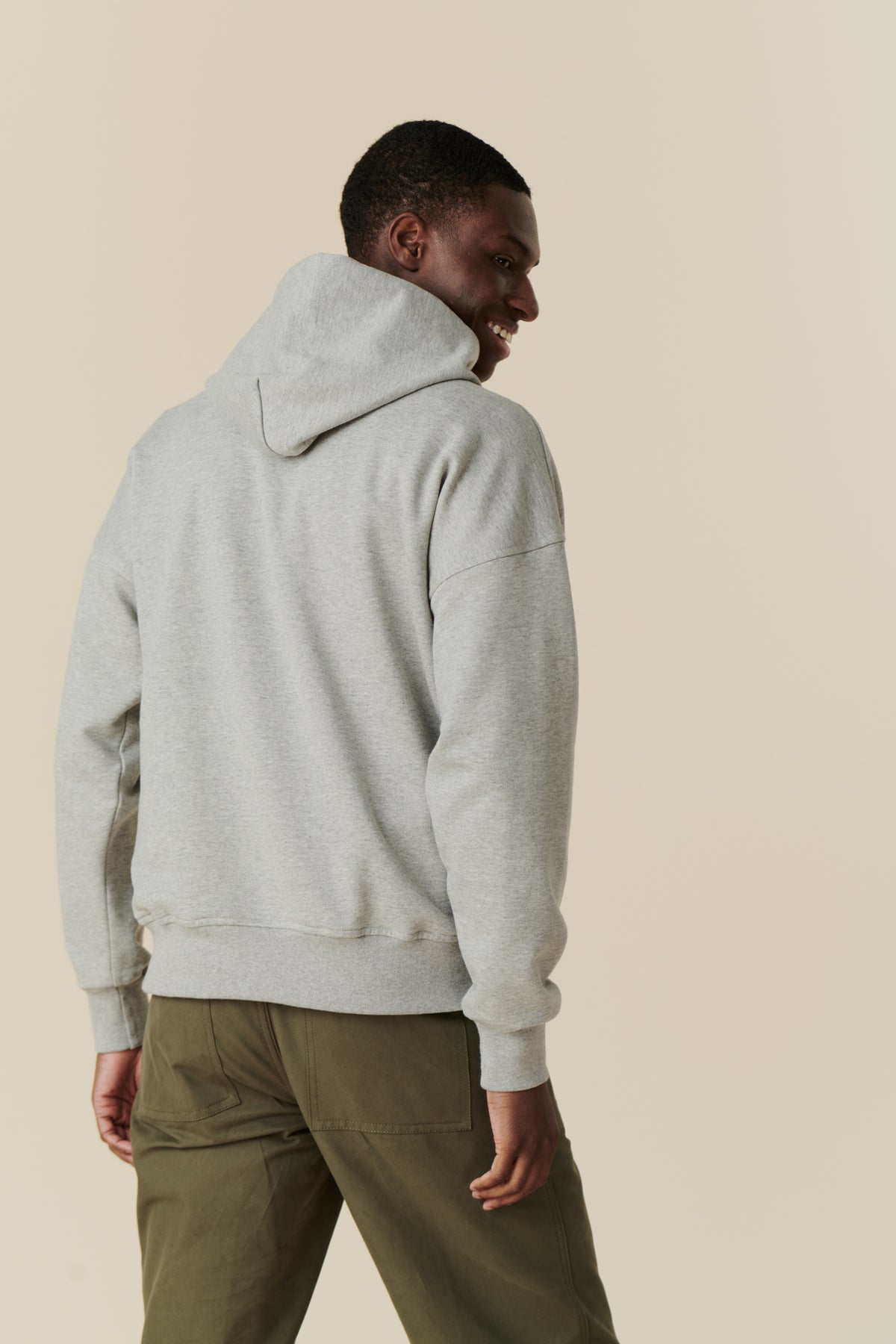 Male wearing hooded sweatshirt in grey