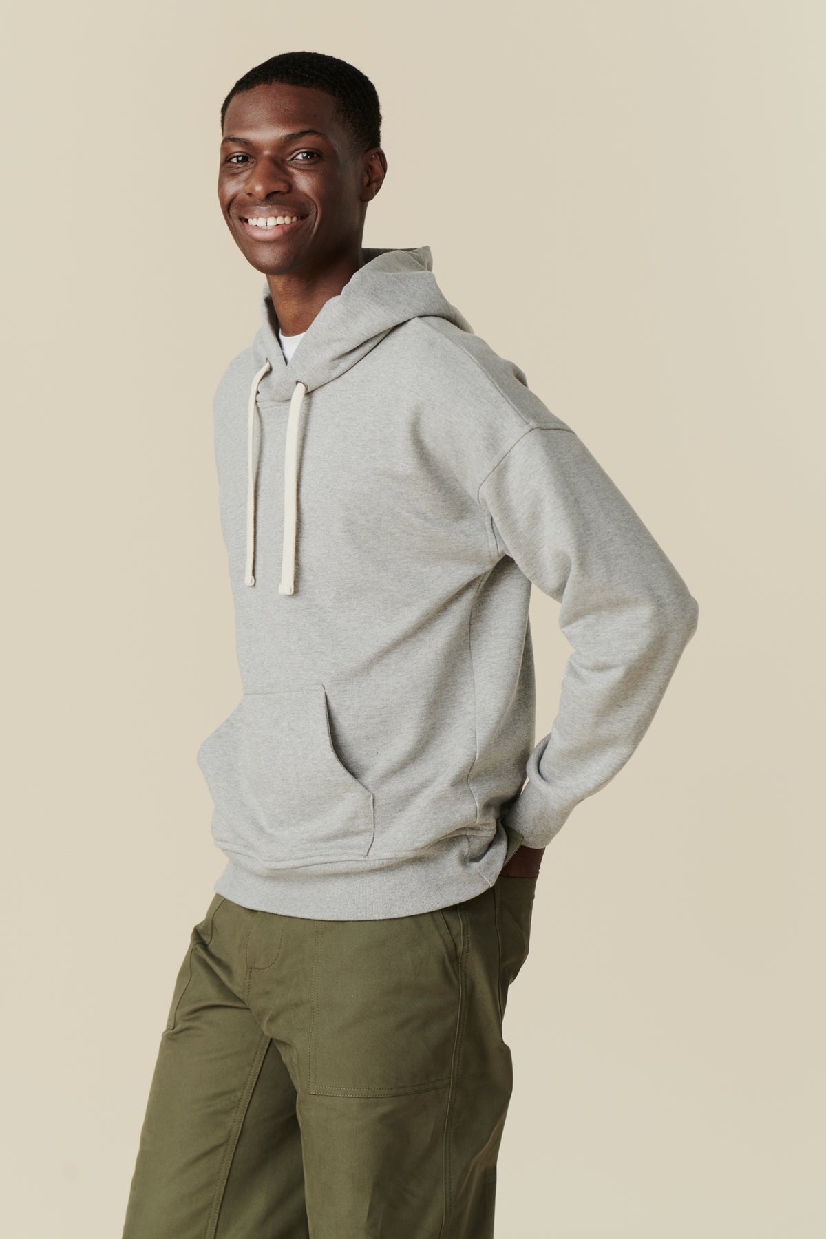 Male wearing hooded sweatshirt in grey