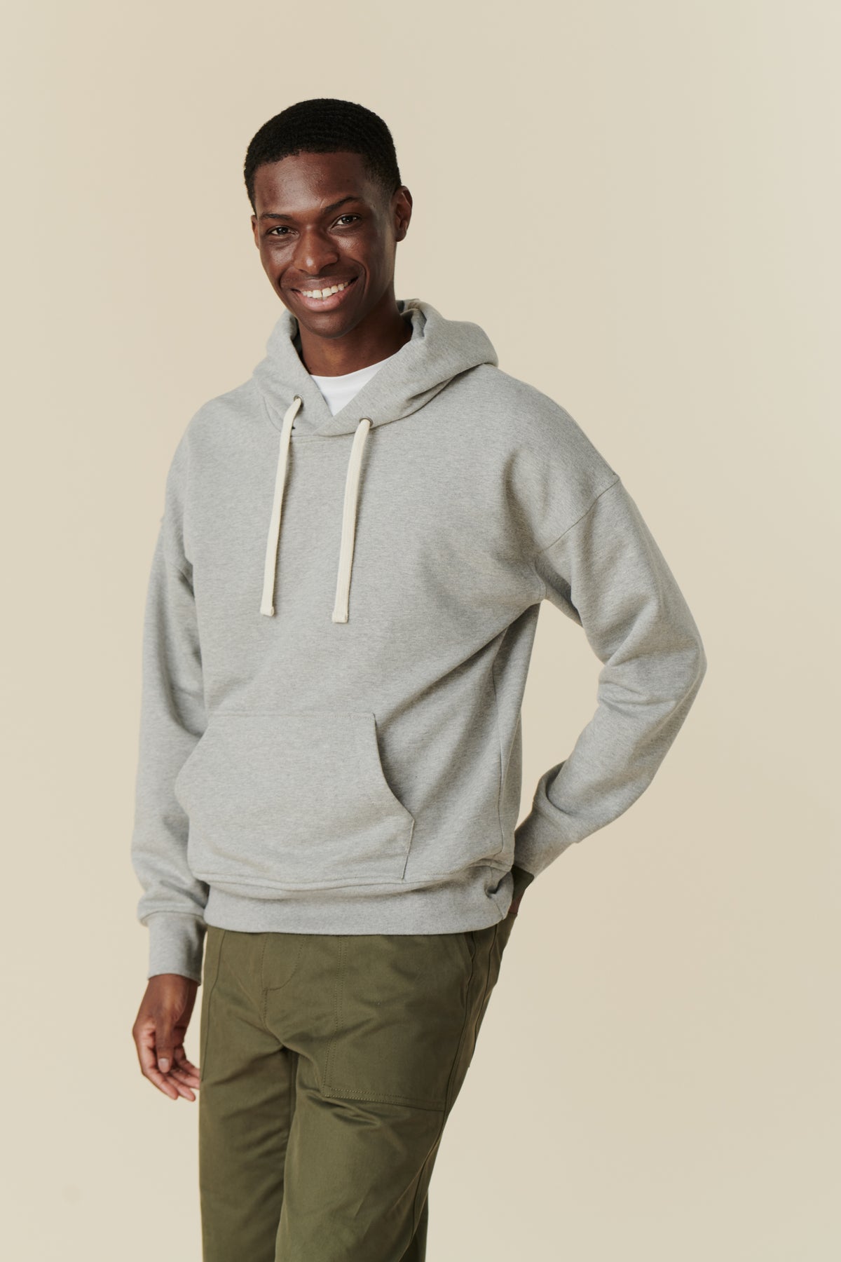 Male wearing hooded sweatshirt in grey