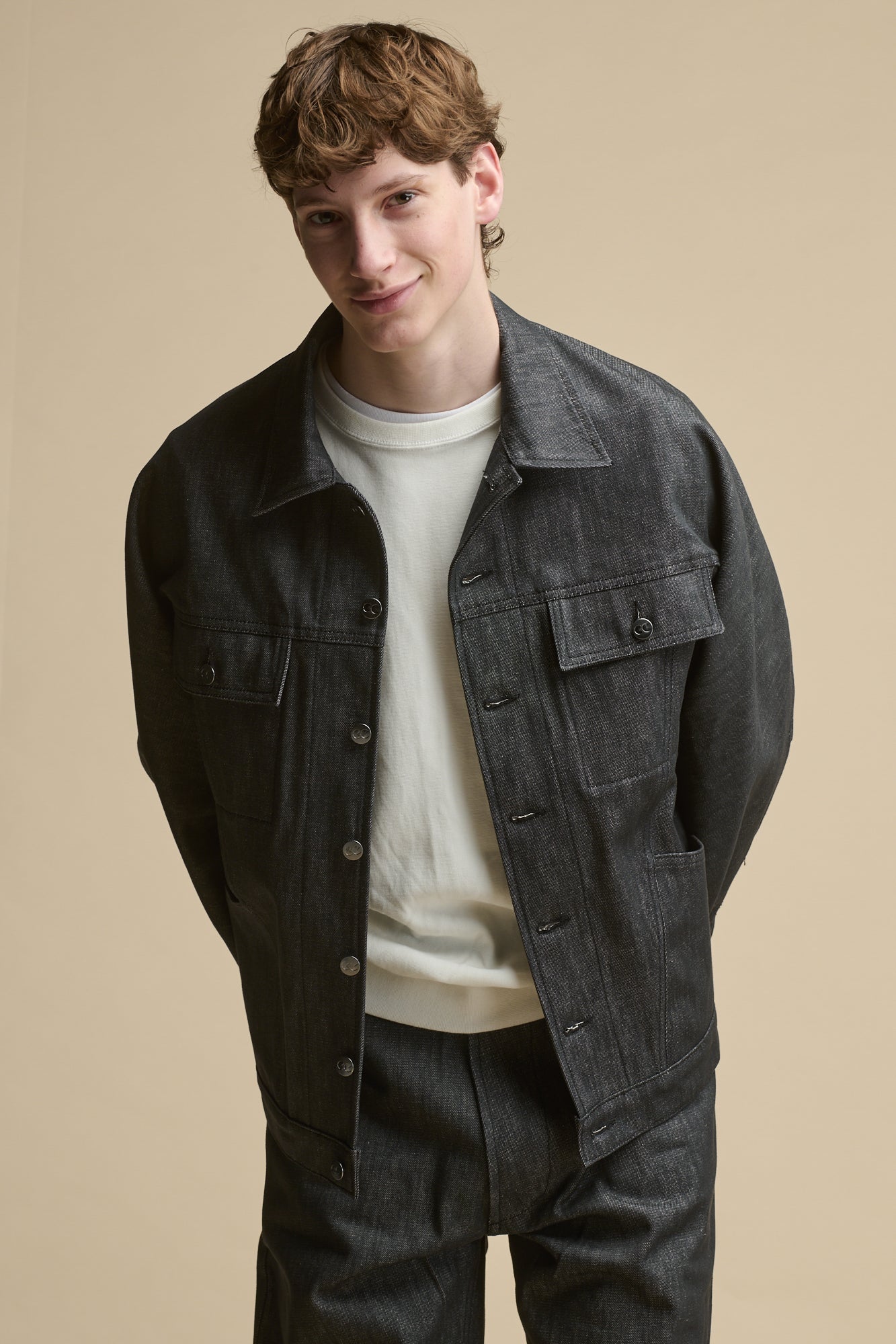 Thigh up image of Men's Joe Denim Jacket in black with two front chest pockets with flaps.