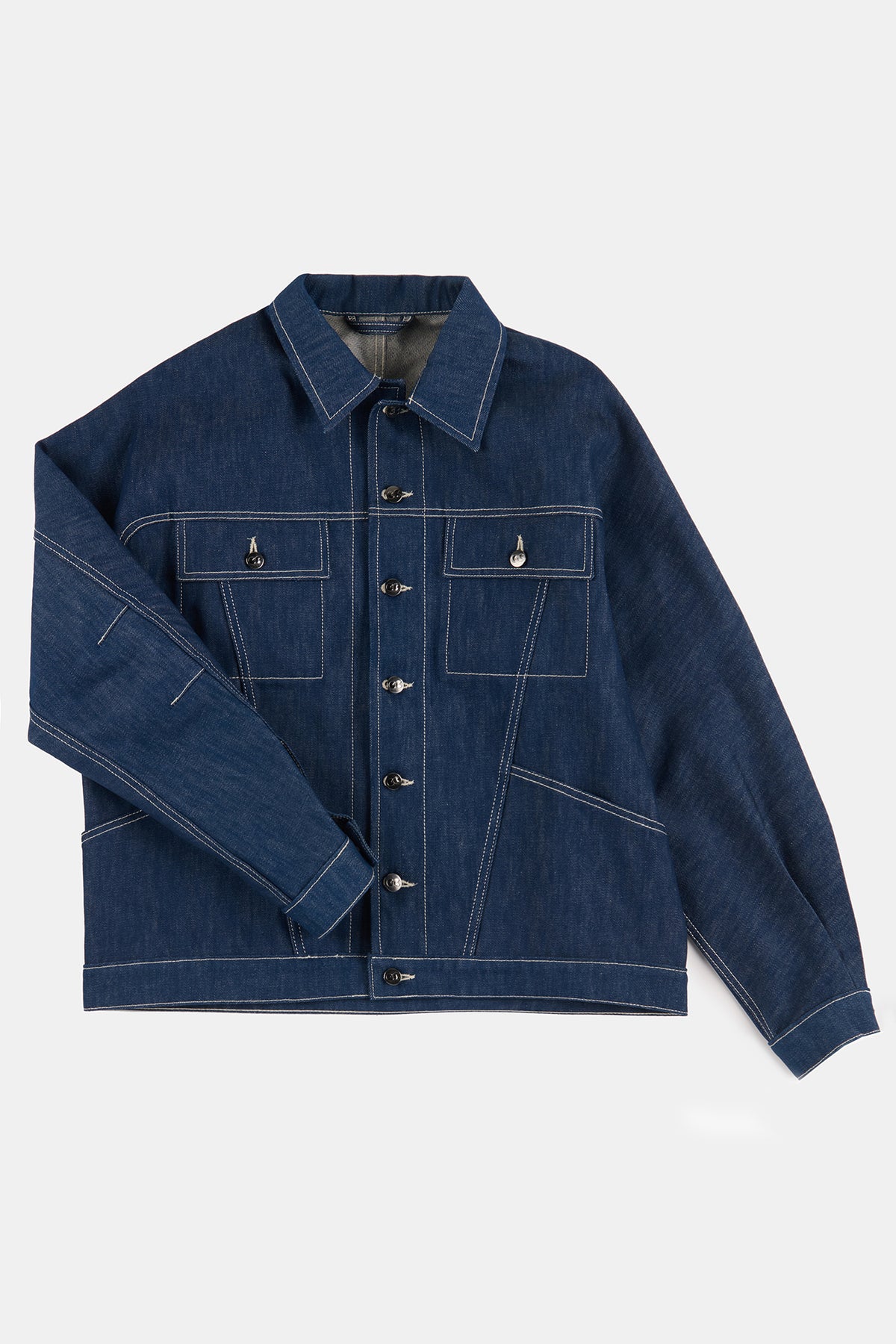 
            Flatlay product shot of men&#39;s Joe denim jacket in blue denim with contrast white stitching 
