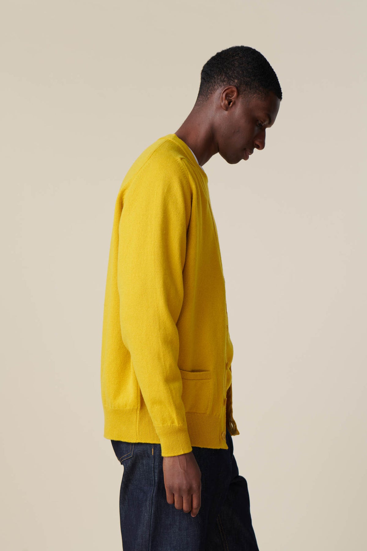 
            Side of male wearing lambswool cardigan in picalilli yellow