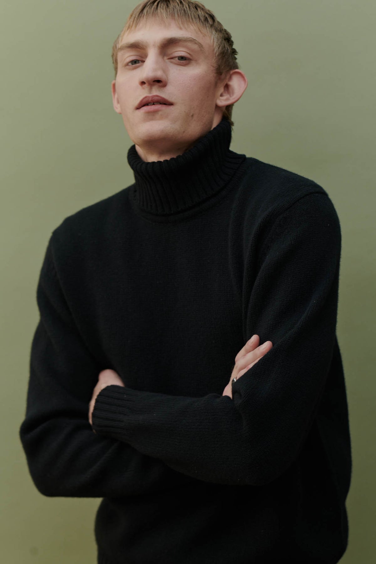 
            Male wearing Lambswool roll neck in black