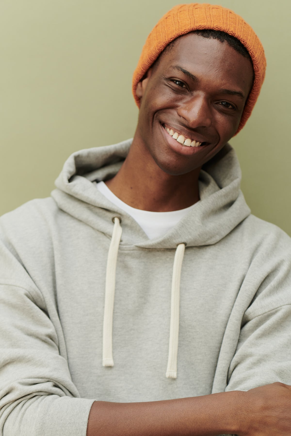 
            Male wearing unisex lambswool beanie hat in rust