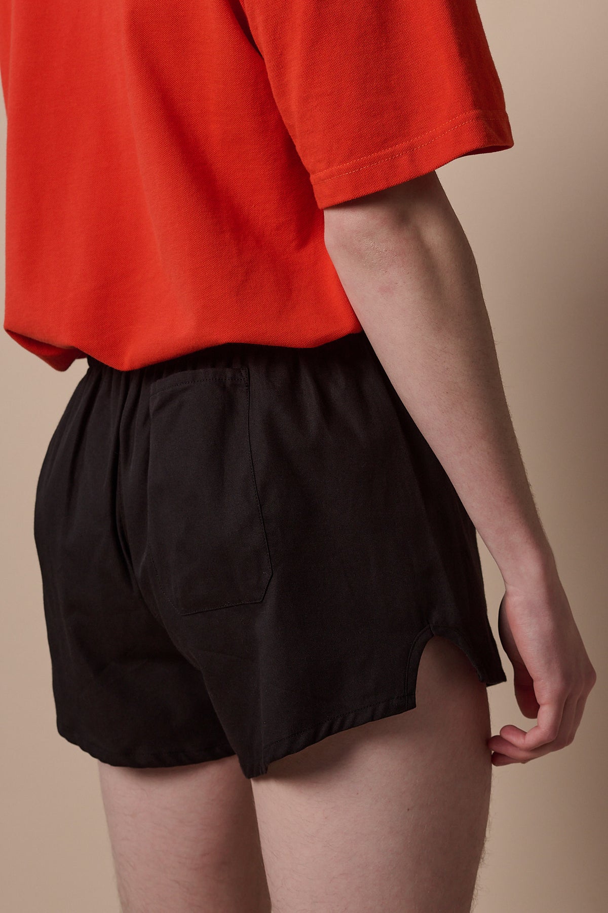 Close up of back of lightweight sports short plastic free in black with pocket