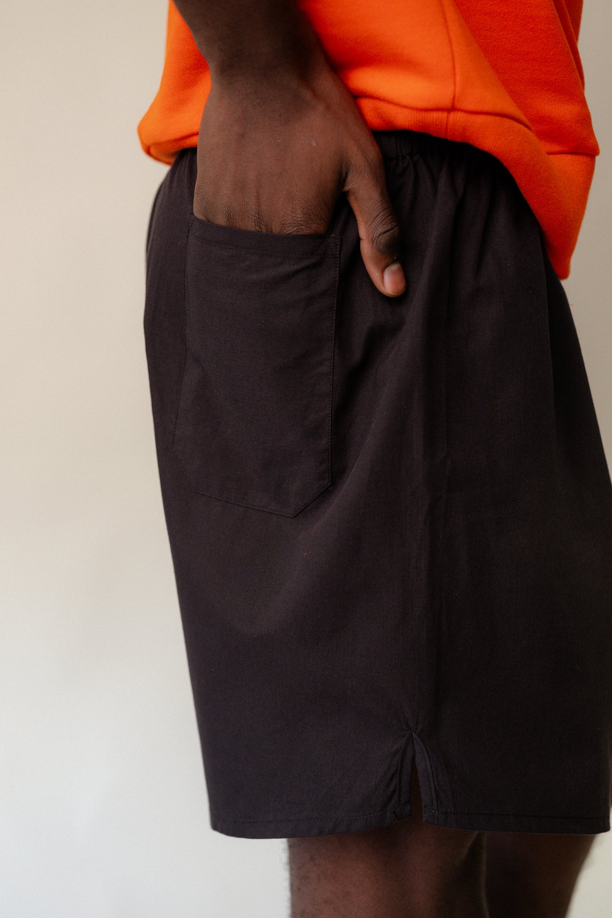 Image of black male wearing long lightweight sports short plastic free in black with CCOA logo