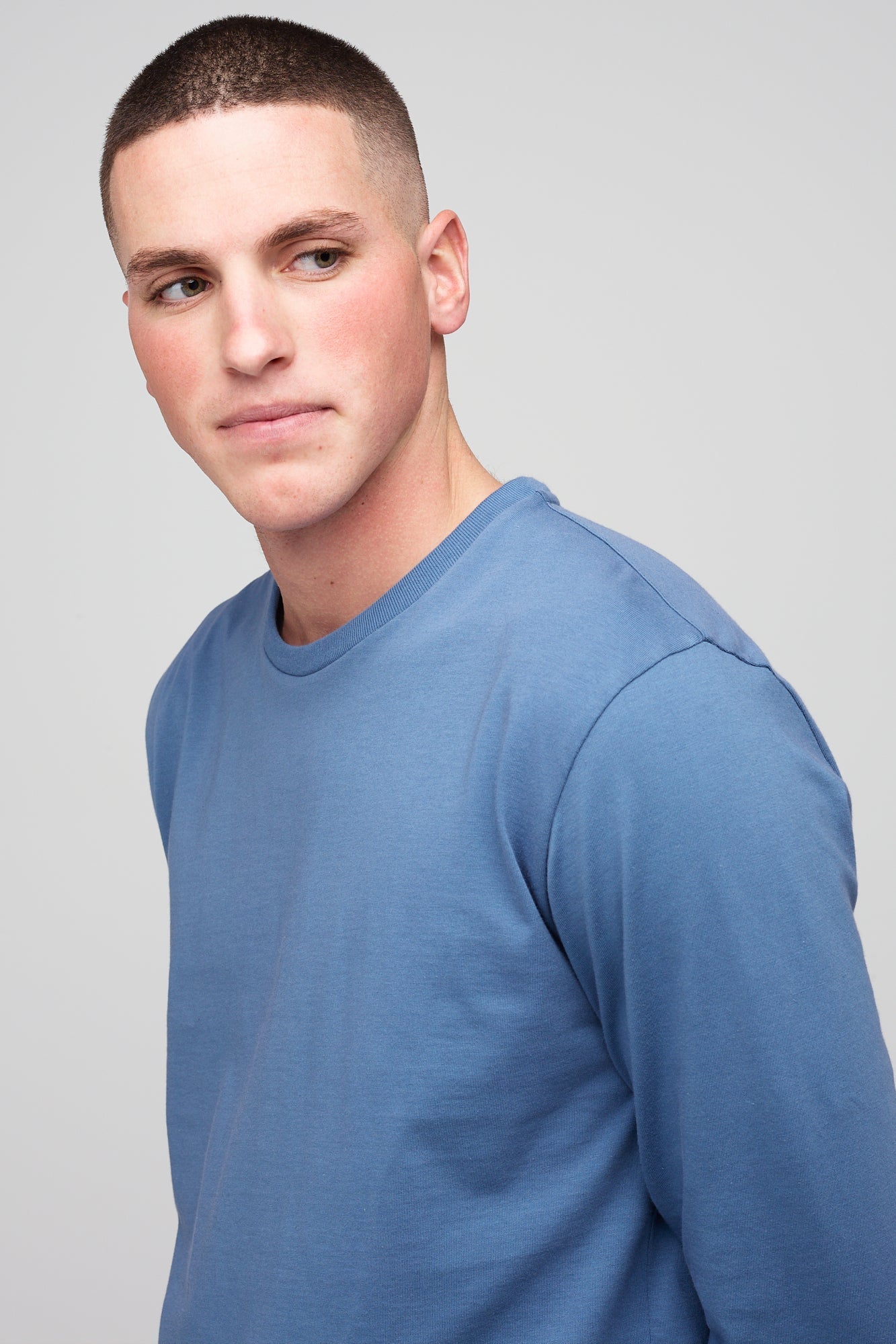 Brunette, white male wearing long sleeve t-shirt in RAF blue