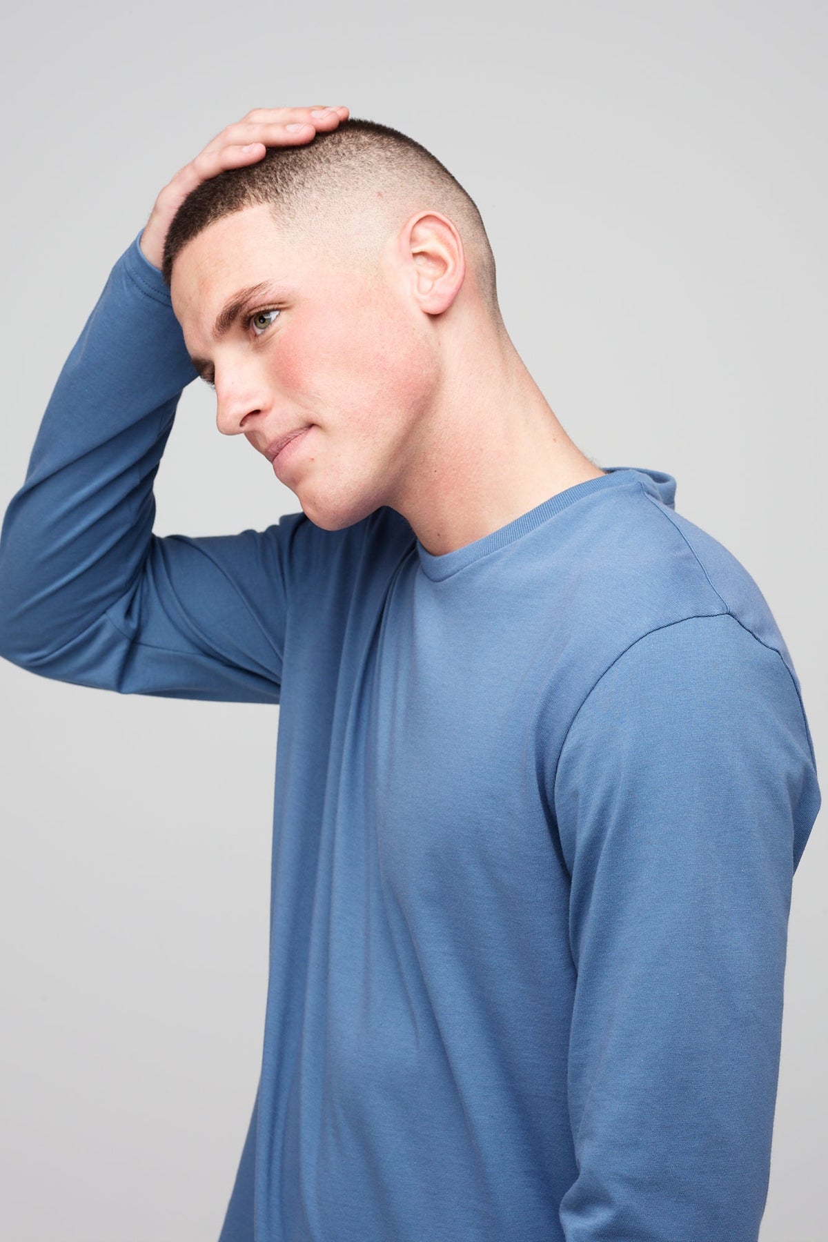 Brunette, white male wearing long sleeve t-shirt in RAF blue
