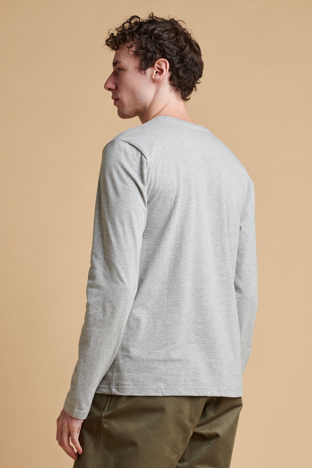 The back of male wearing long sleeve t shirt in grey marl.