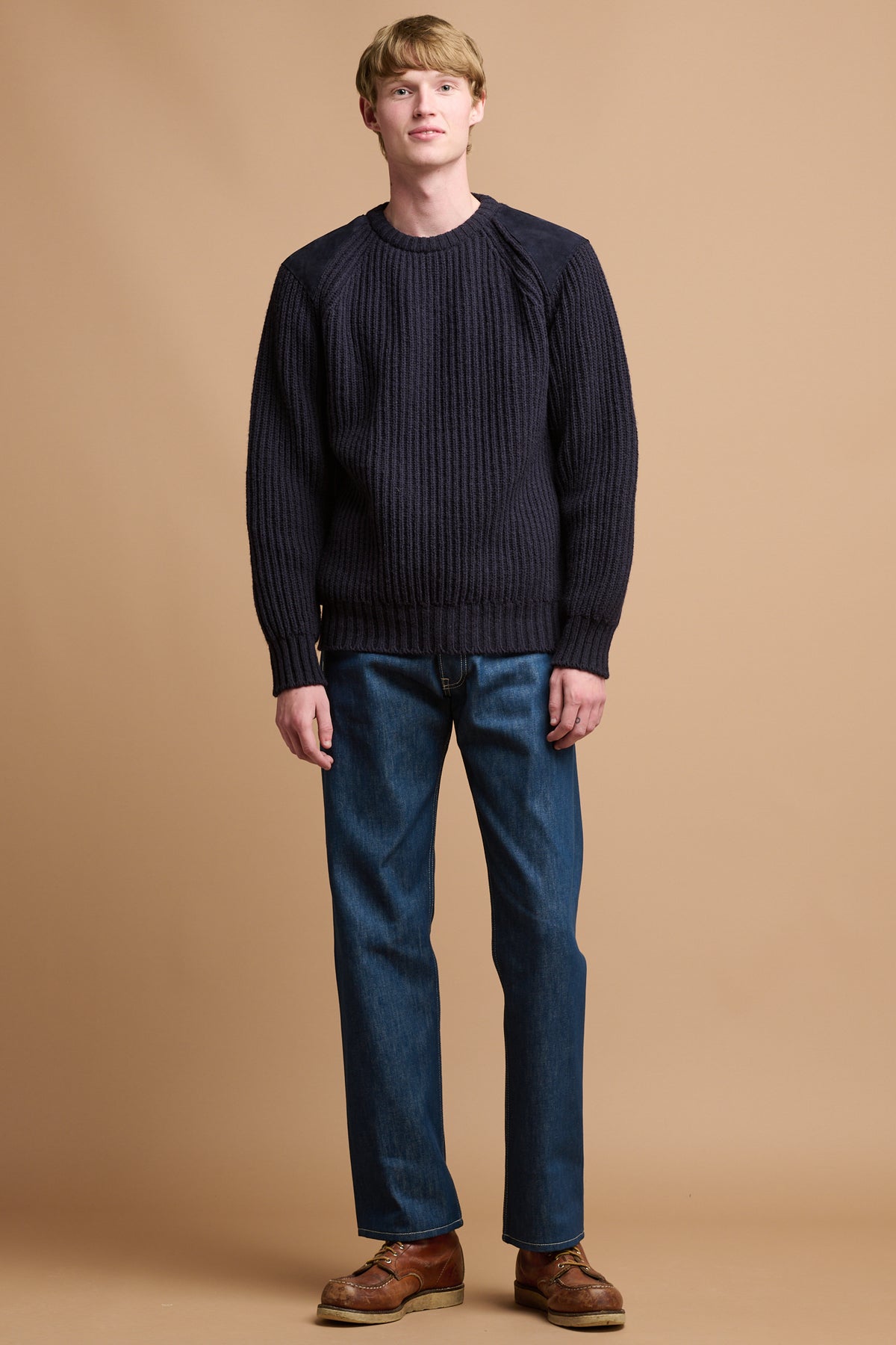 Male wearing Community Clothing button fly Arran jean in blue paired with lambswool ribbed jumper