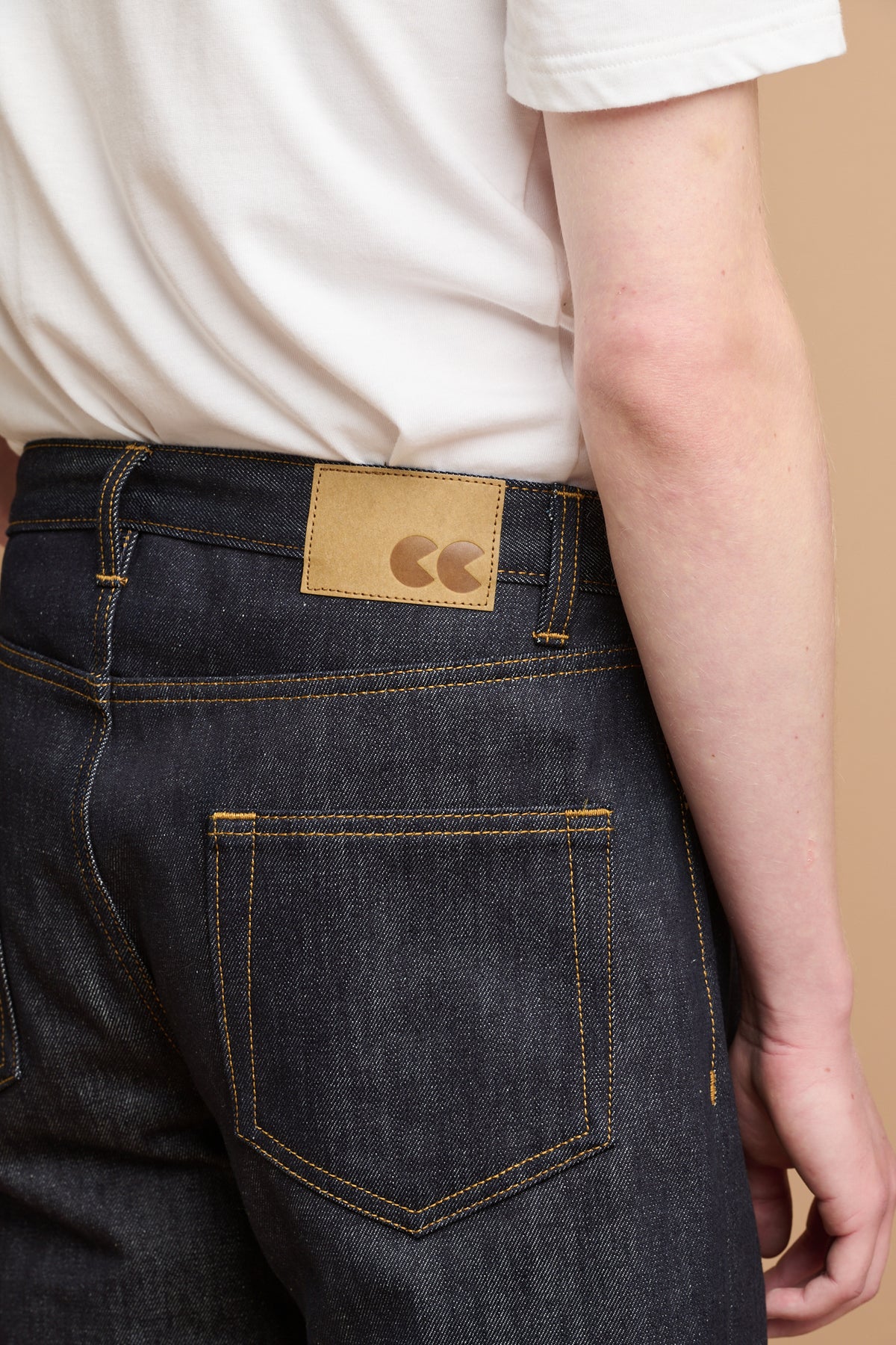 Close up of the back of selvedge denim jeans with CC logo jeans patch.