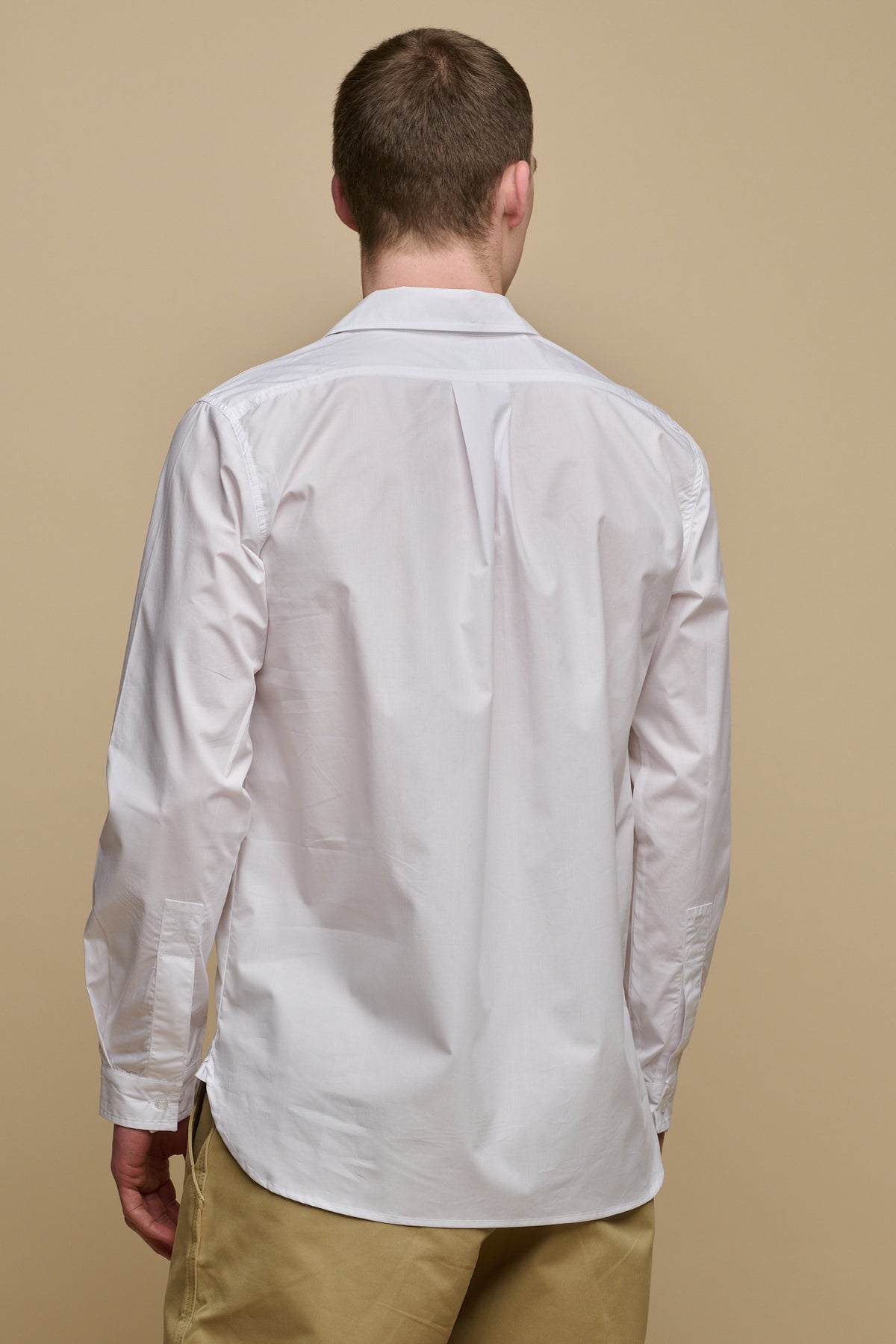 
            Thigh up image of the back of male wearing Oli half placket lightweight cotton shirt in white 