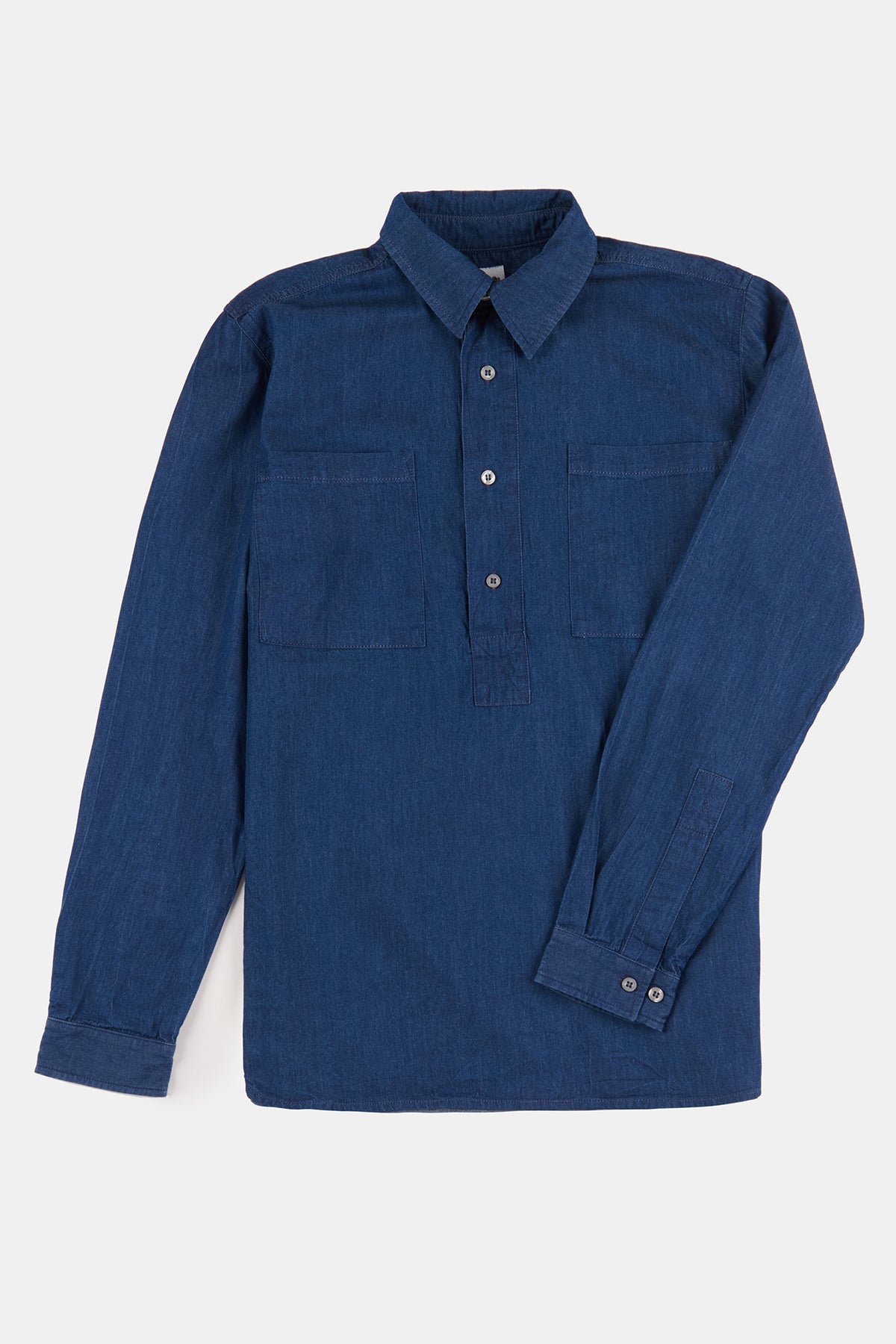 Flatlay product shot of men's half placket lightweight denim shirt in indigo