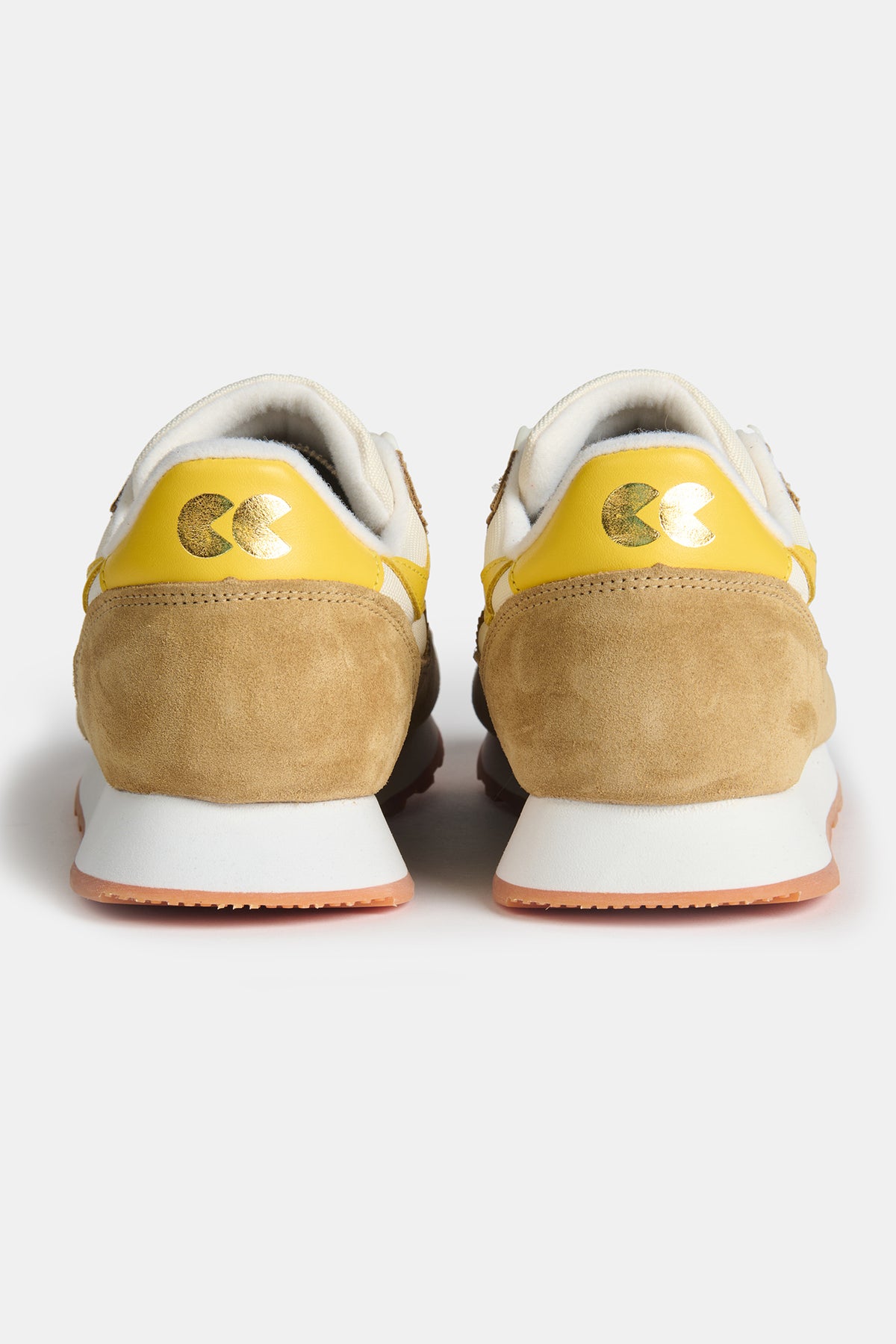 The heel of Men's Parlick trainer in Ivory tan yellow with gold foil CC logo