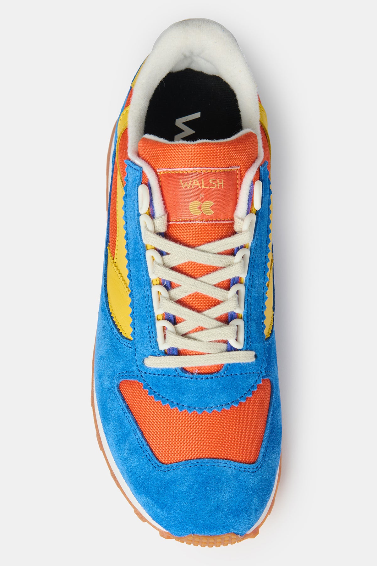 The top of men's Parlick trainer in orange bright cobalt and yellow with WALSH X CC embroidered into into orange tongue