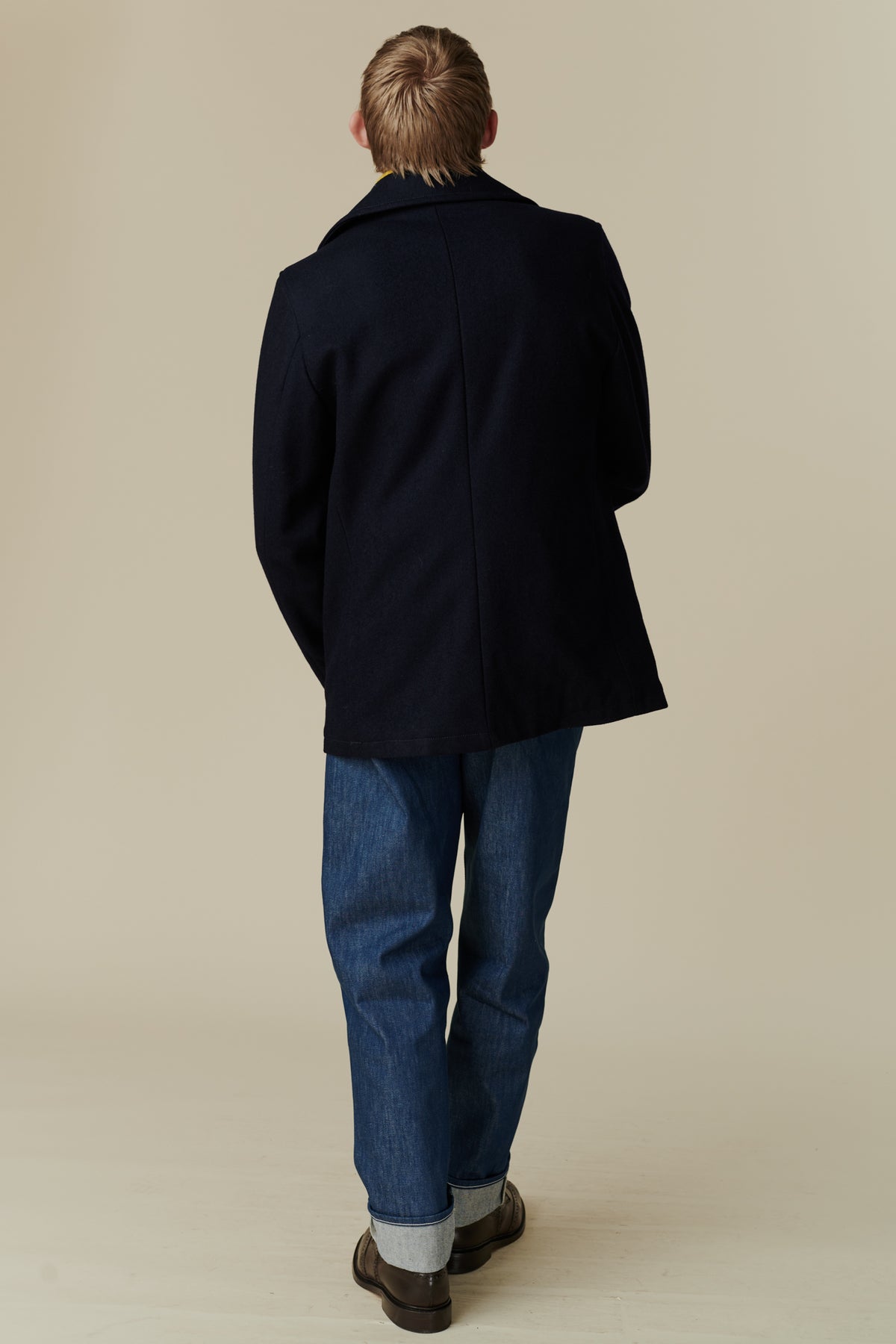 Back of male wearing pea coat in navy