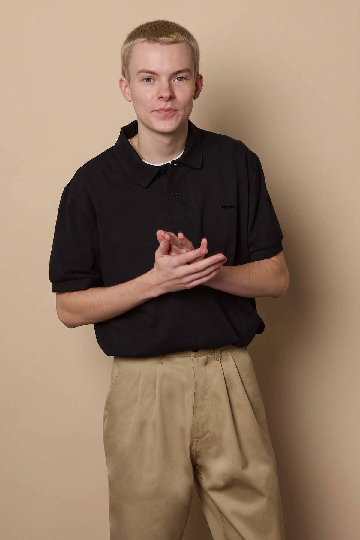Knee up image of male wearing pleated chino in stone