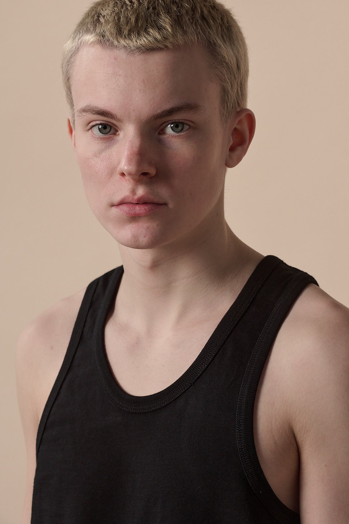 Portrait of male wearing men's racer back vest plastic free in black