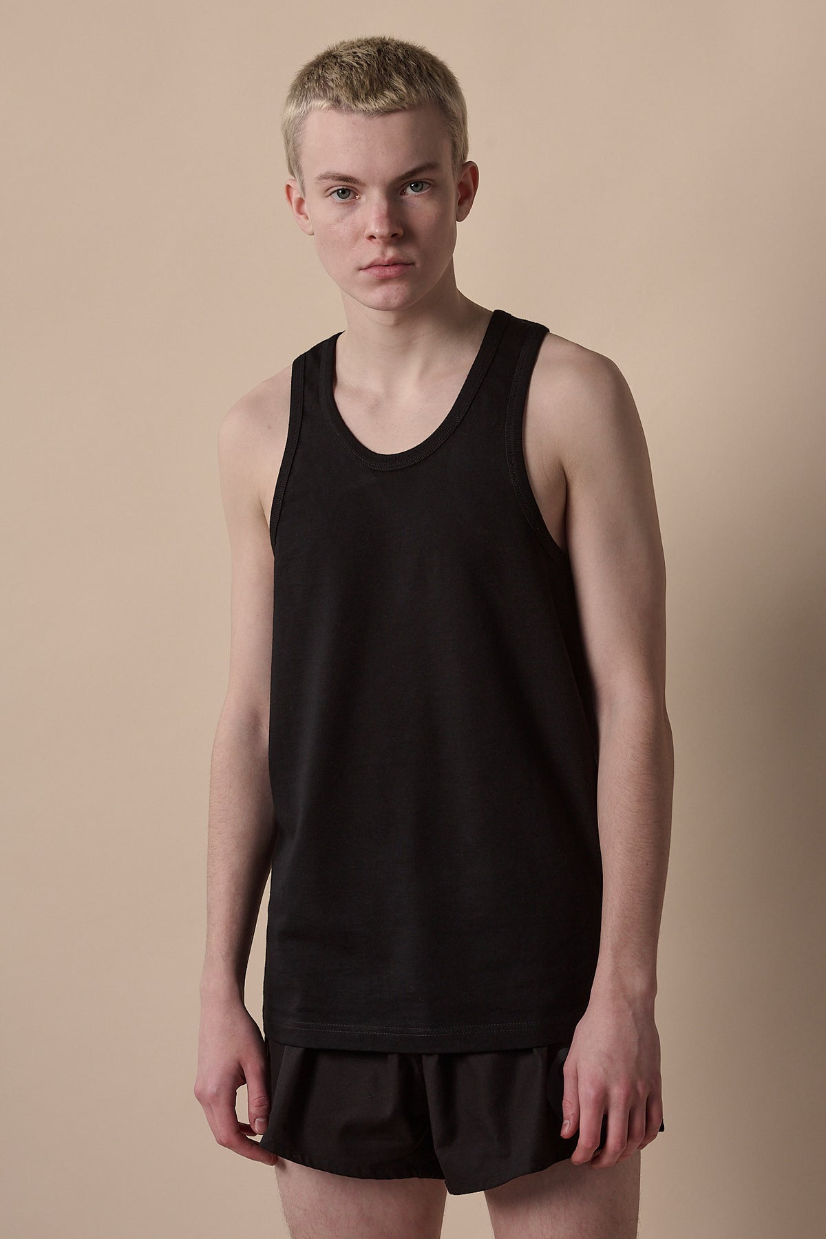 White male wearing racer back vest plastic free in black